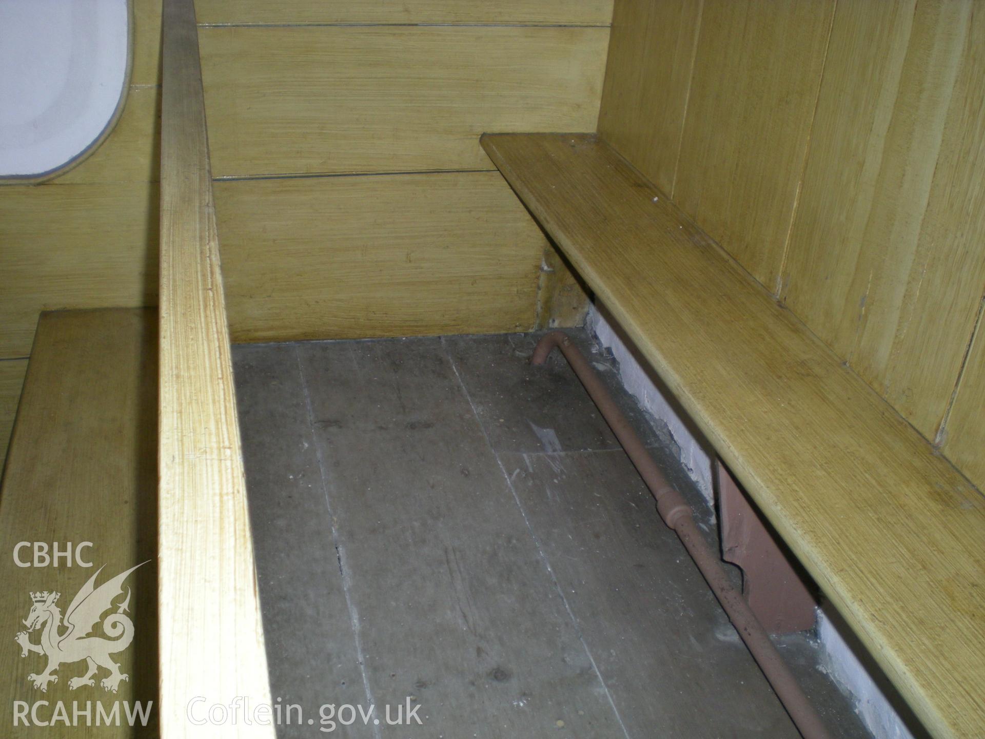 Colour photograph showing detail of the pews.