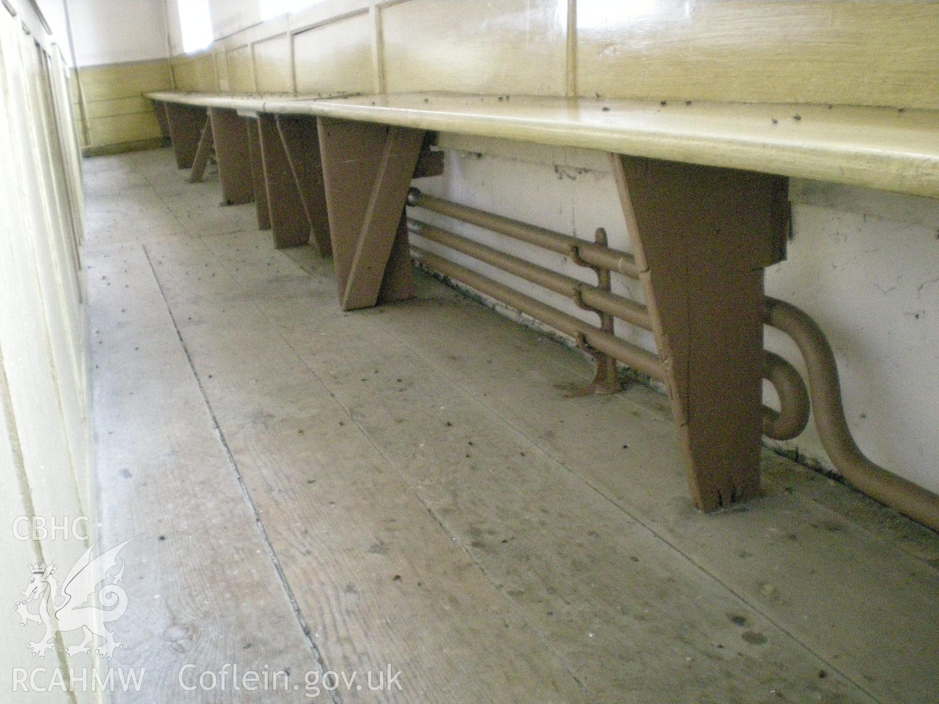 Colour photograph showing detail of the pews.