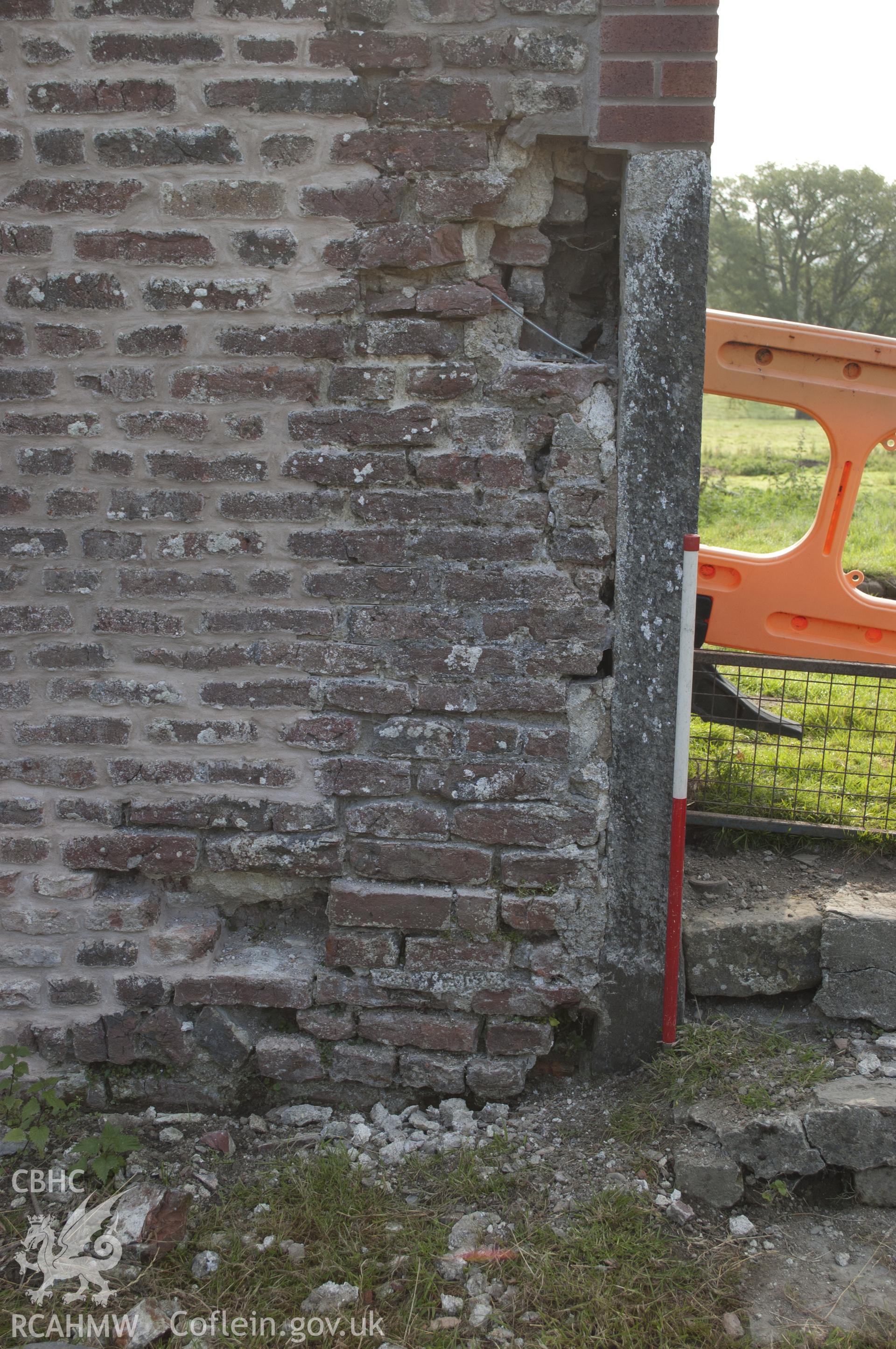 View from north-west showing dressed stone base of arch in eastern wall, kitchen garden.