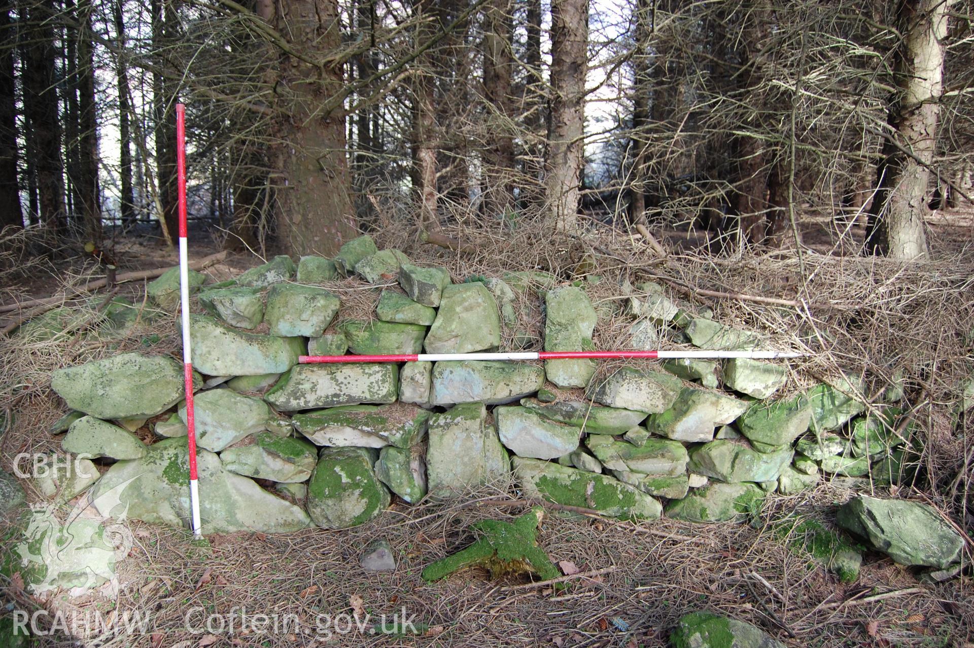 Photo showing 'Section of Wall which appears to survive to the original height and width to the south of the suggested breaching point' from Archaeological Assessment of Nant Gwrtheyrn Lower Car Park, Nant Gwrtheyrn, Gwynedd produced by Gwynedd Archaeological Trust in 2013, Project No. G2313, Report No.1208.