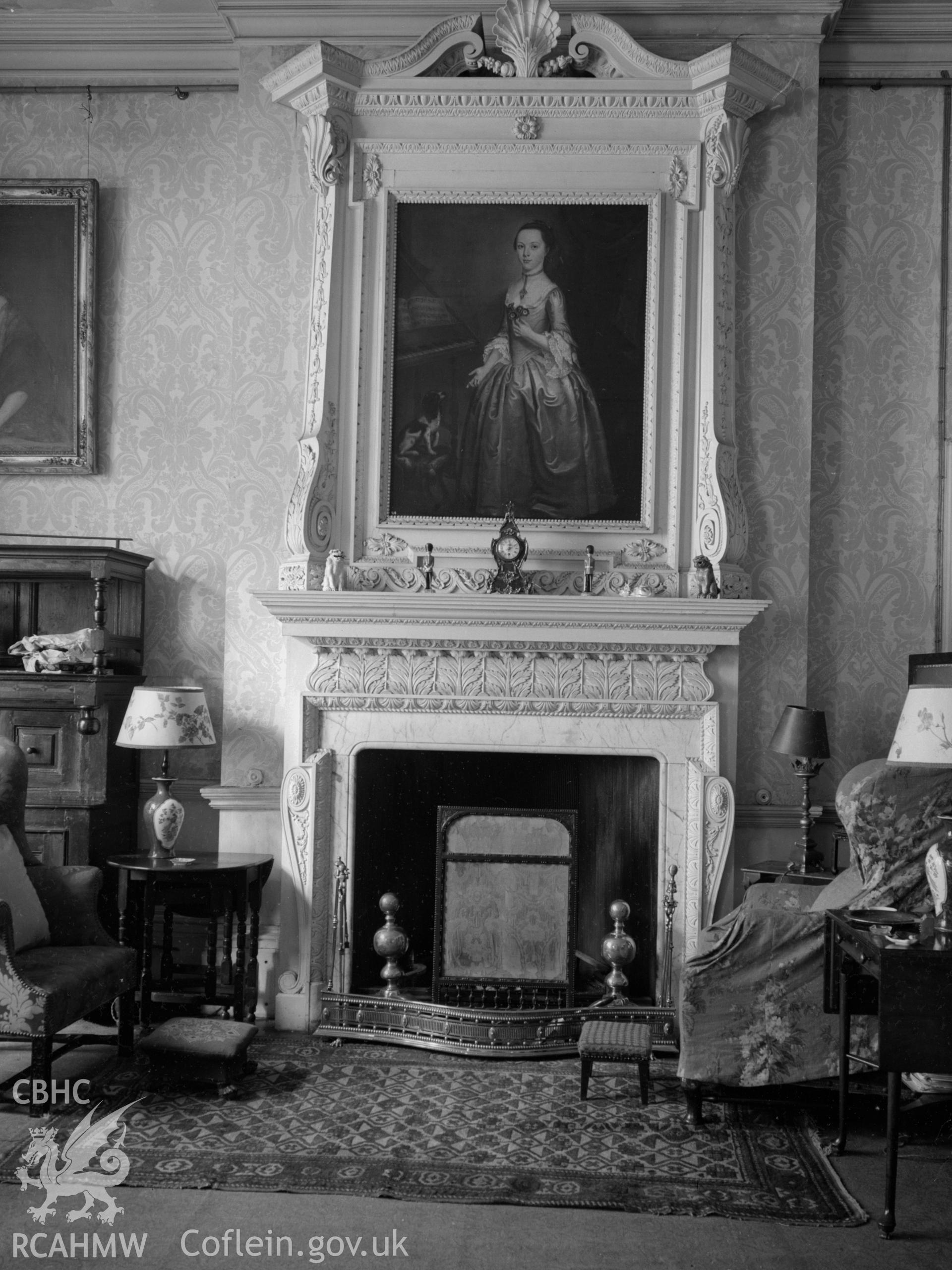 A carved marble fireplace, in the dining room.