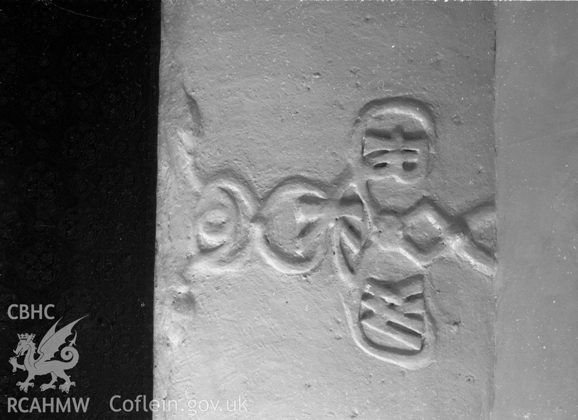 A view of plasterwork over ground fireplace with the inscription IRKW.