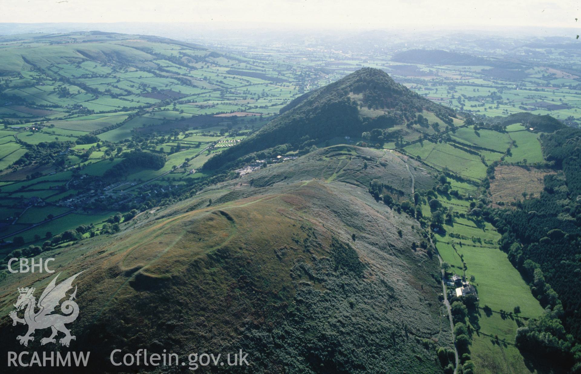 Slide of RCAHMW colour oblique aerial photograph of Breiddin Hillfort Multiple Site (s), taken by C.R. Musson, 4/10/1994.