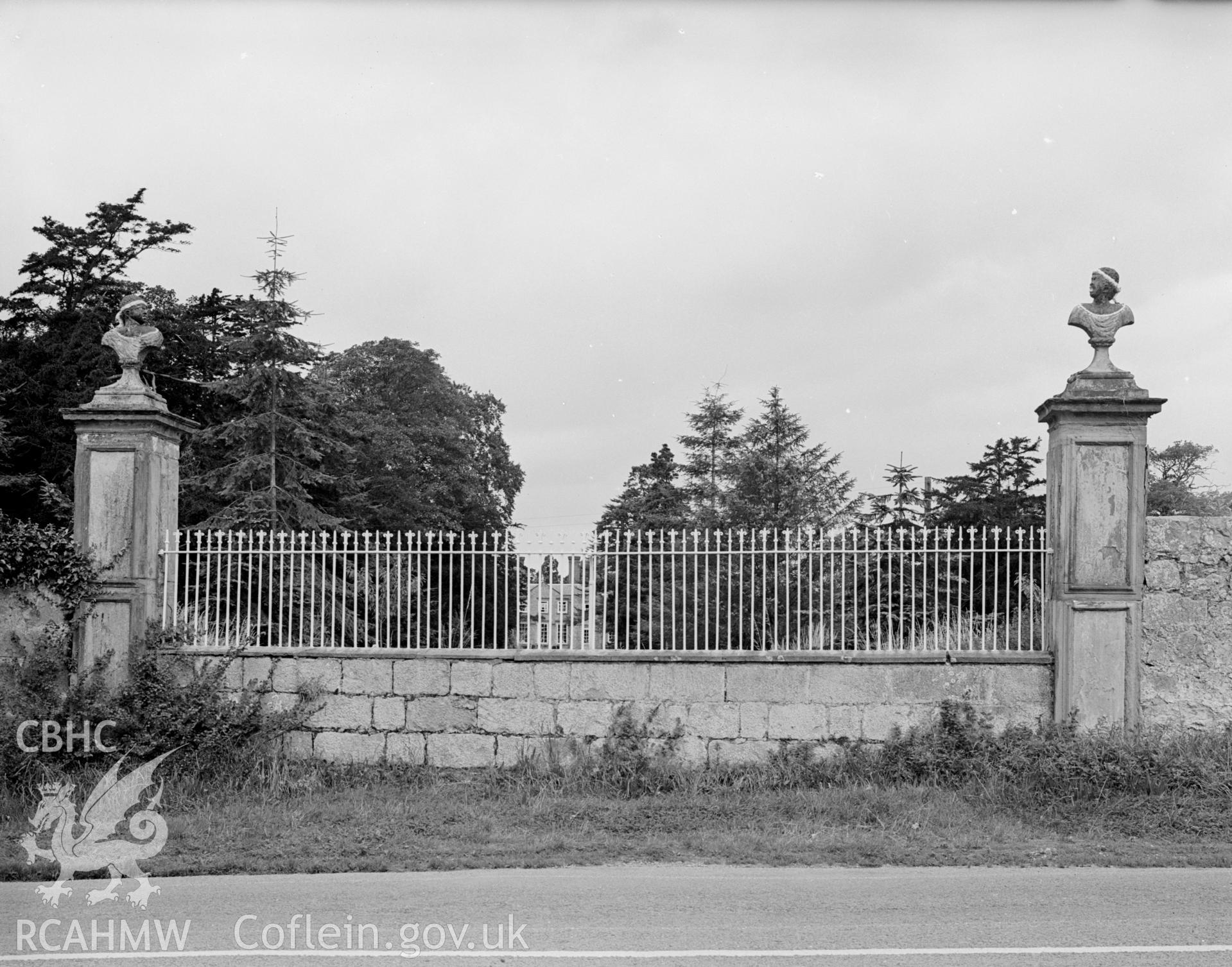 A view of Bodrhyddan Hall, through iron fencing, where the original gates once stood.