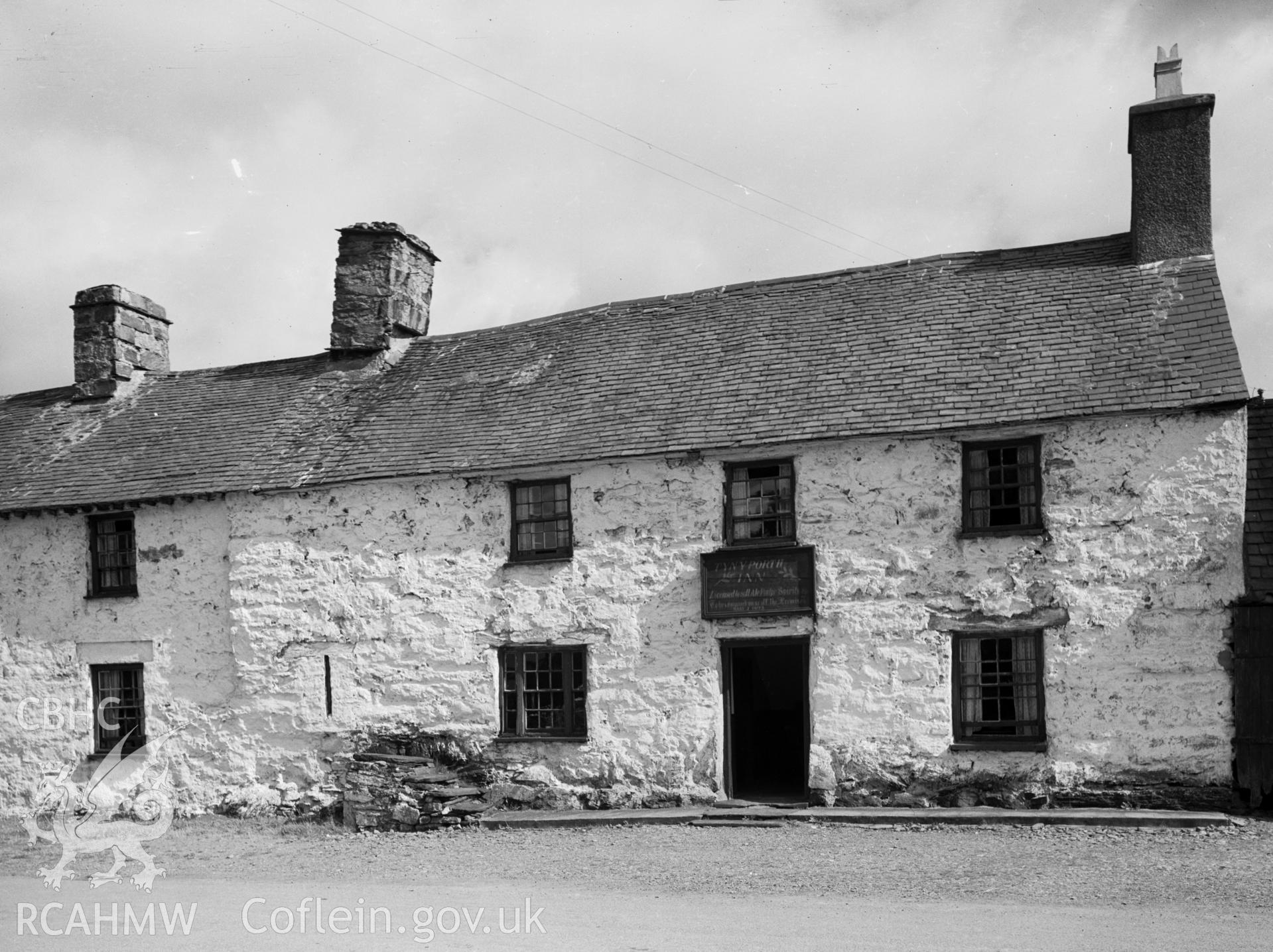 A long rectangular stone building with slate roof pitched roof and two chimneys.