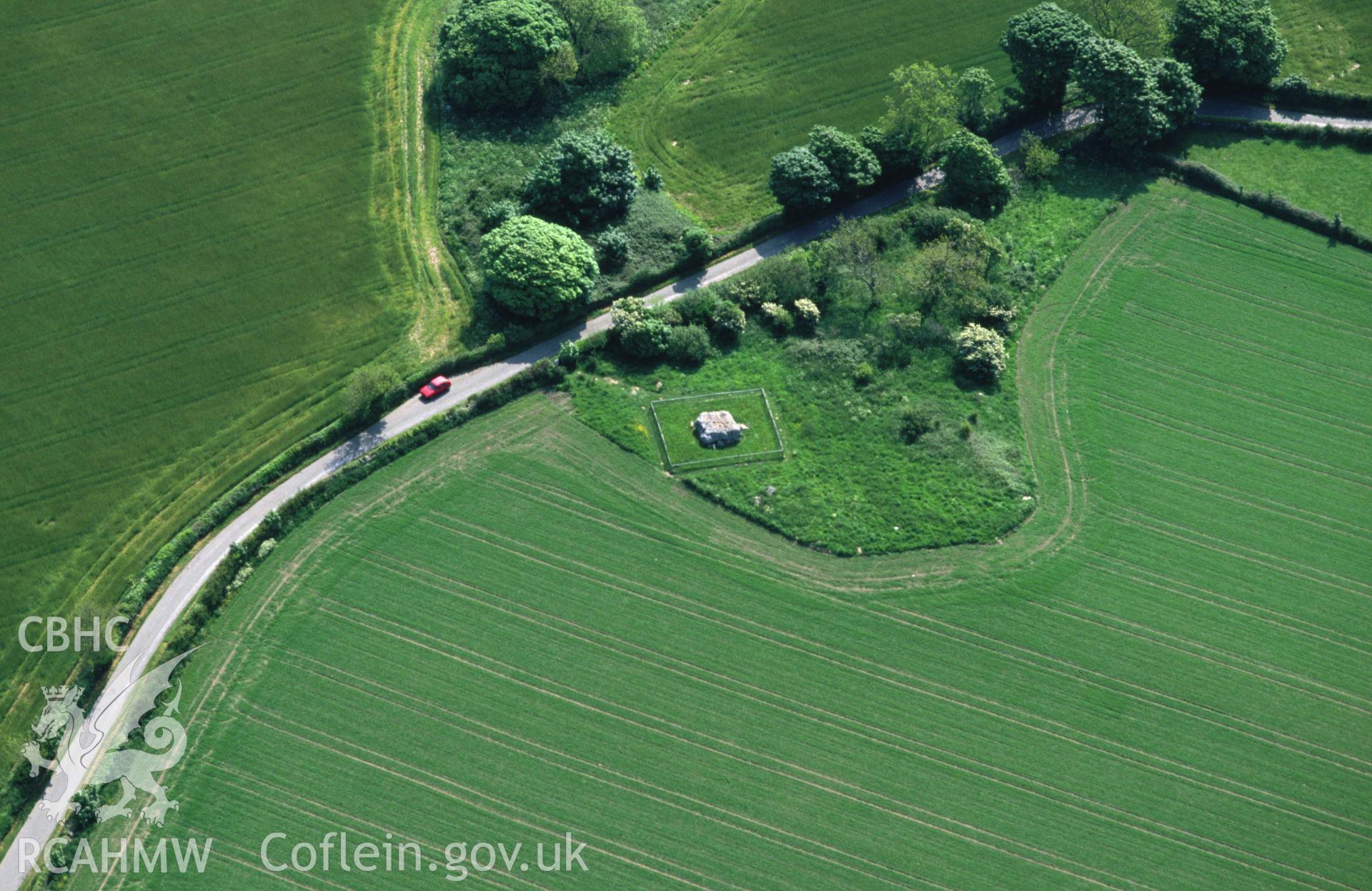 Slide of RCAHMW colour oblique aerial photograph of Lligwy Burial Chamber, taken by C.R. Musson, 30/5/1994.