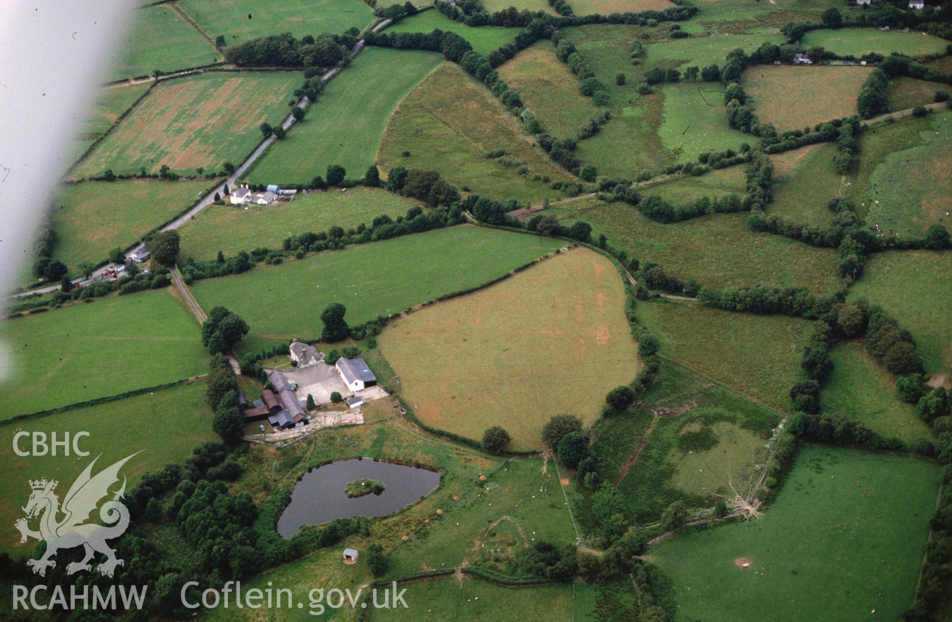 Slide of RCAHMW colour oblique aerial photograph of Llanio Roman Fort And Bathhouse, taken by C.R. Musson, 28/7/1989.