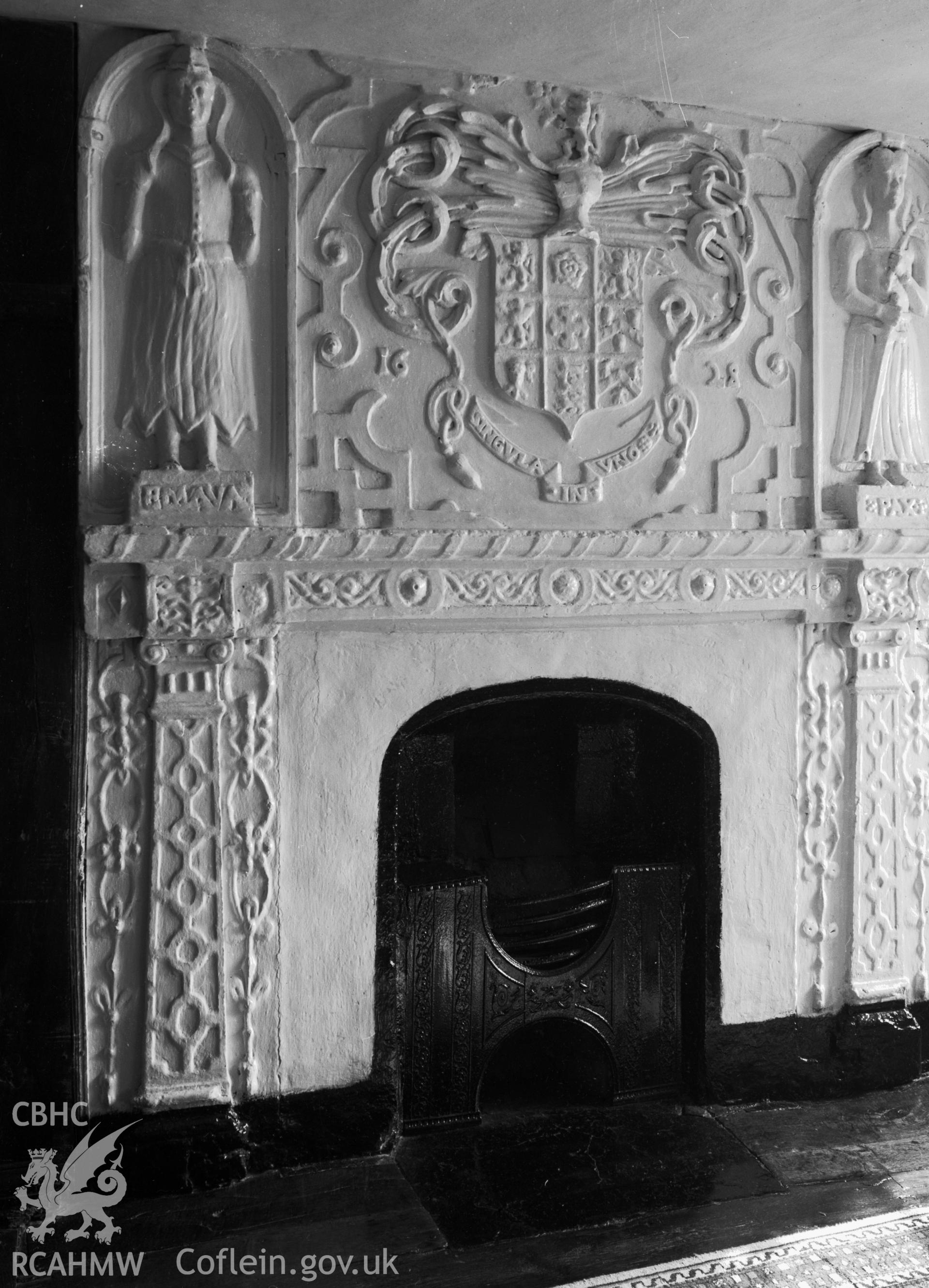 A view of a simple fireplace, with an ornate plasterworks surround. With the date 1628.