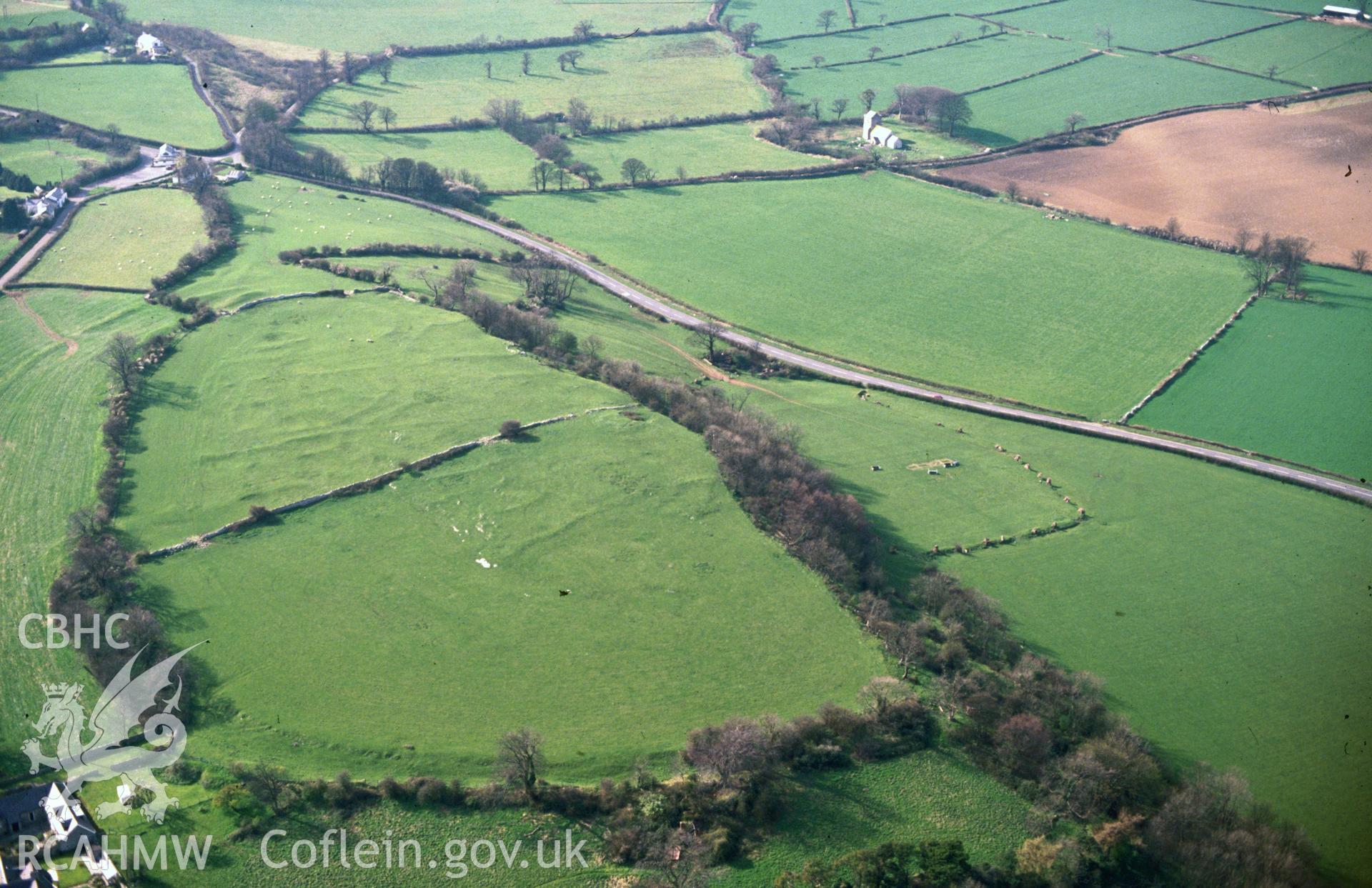 Slide of RCAHMW colour oblique aerial photograph of Caer Dynnaf Hillfort, taken by C.R. Musson, 26/3/1990.