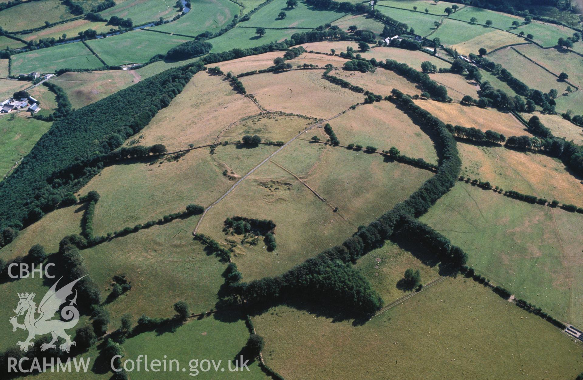 Slide of RCAHMW colour oblique aerial photograph of Pen Coed-foel Camp, taken by C.R. Musson, 26/7/1989.