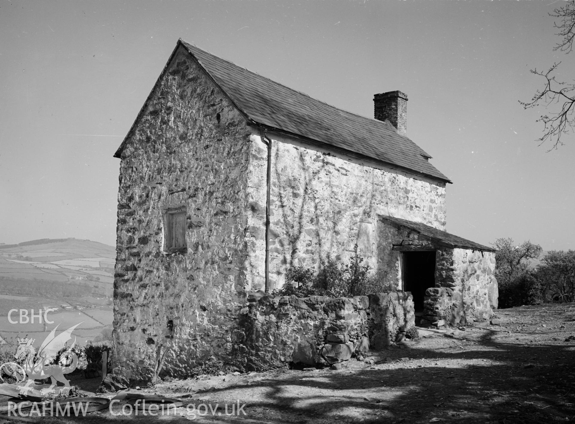 Lletty from the south west, showing a slate roof and a lean-to entrance.