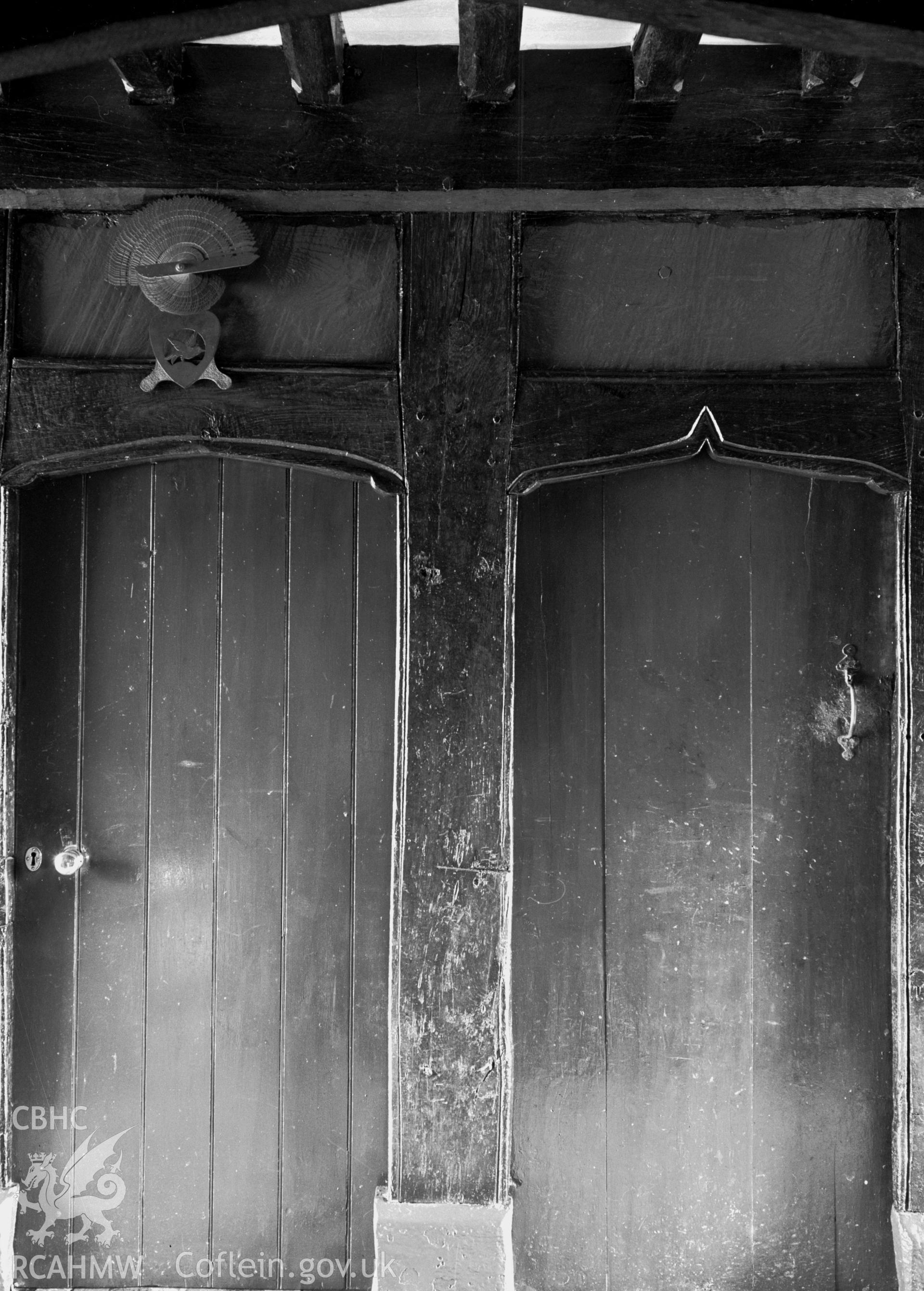 A picture of two simple wooden doorways next to each other.