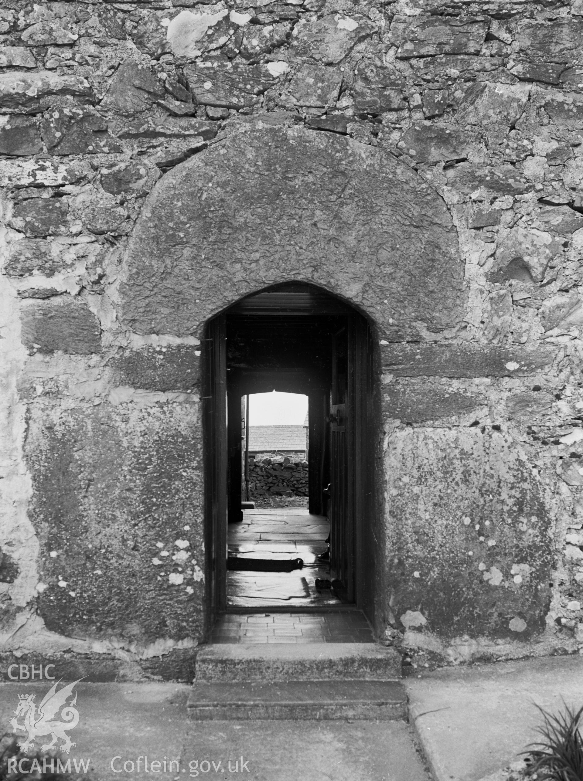 A stone doorway on the south, with one large curved slab above the door.