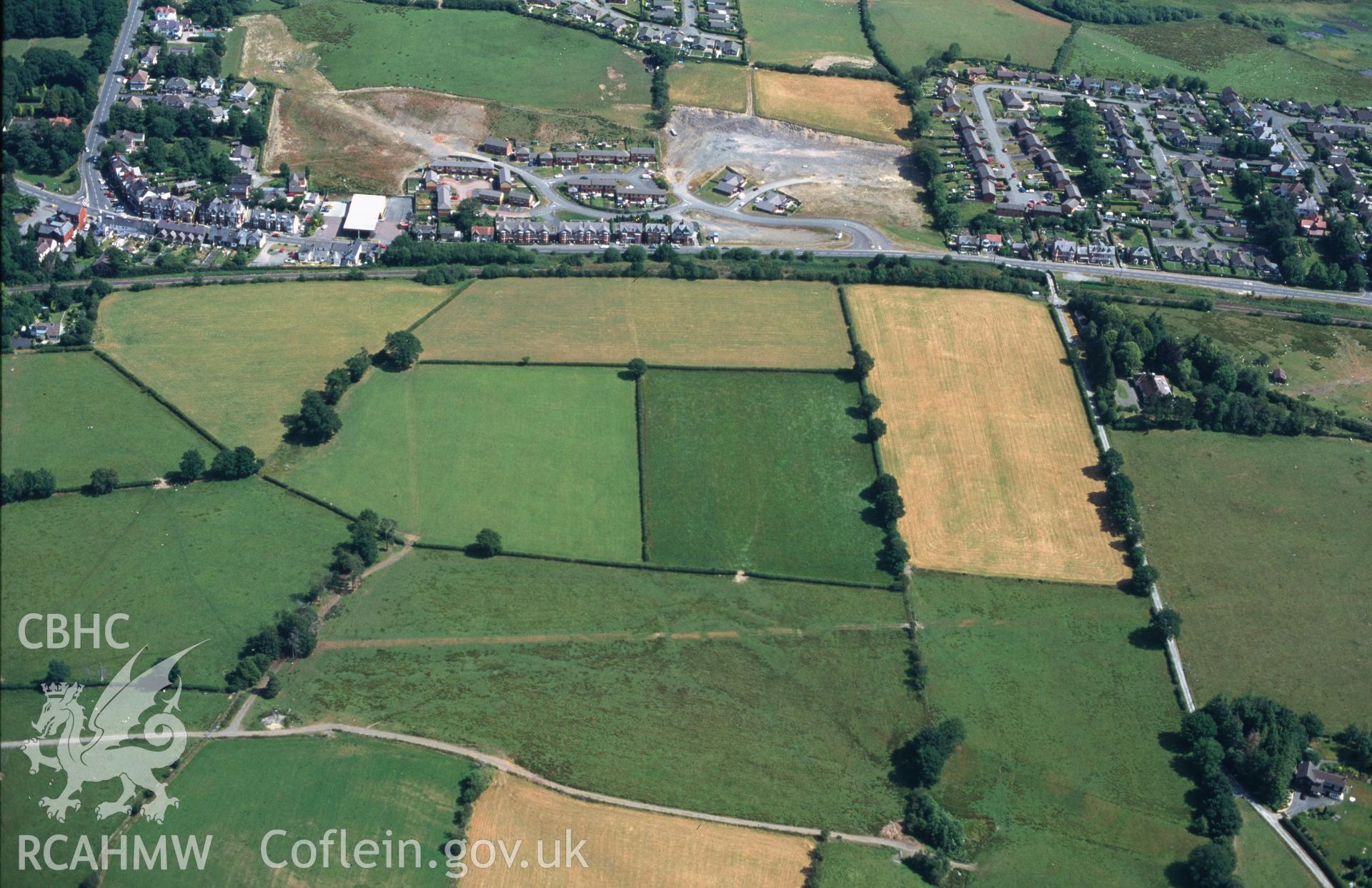 Slide of RCAHMW colour oblique aerial photograph of Roman Earthworks S Of Llandrindod Wells, taken by C.R. Musson, 27/7/1996.