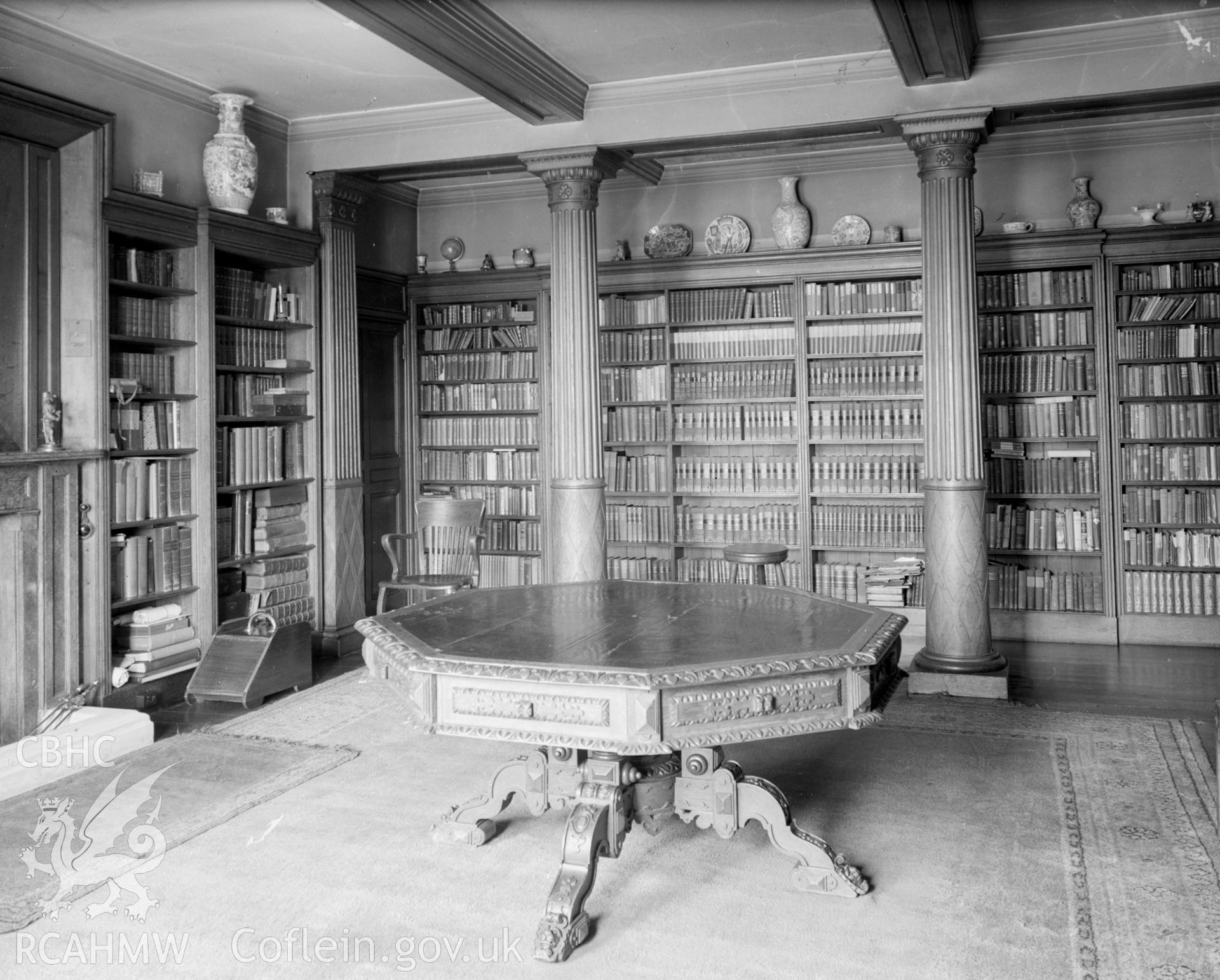 A photograph of the library, showing two columns supporting the beamed ceiling.