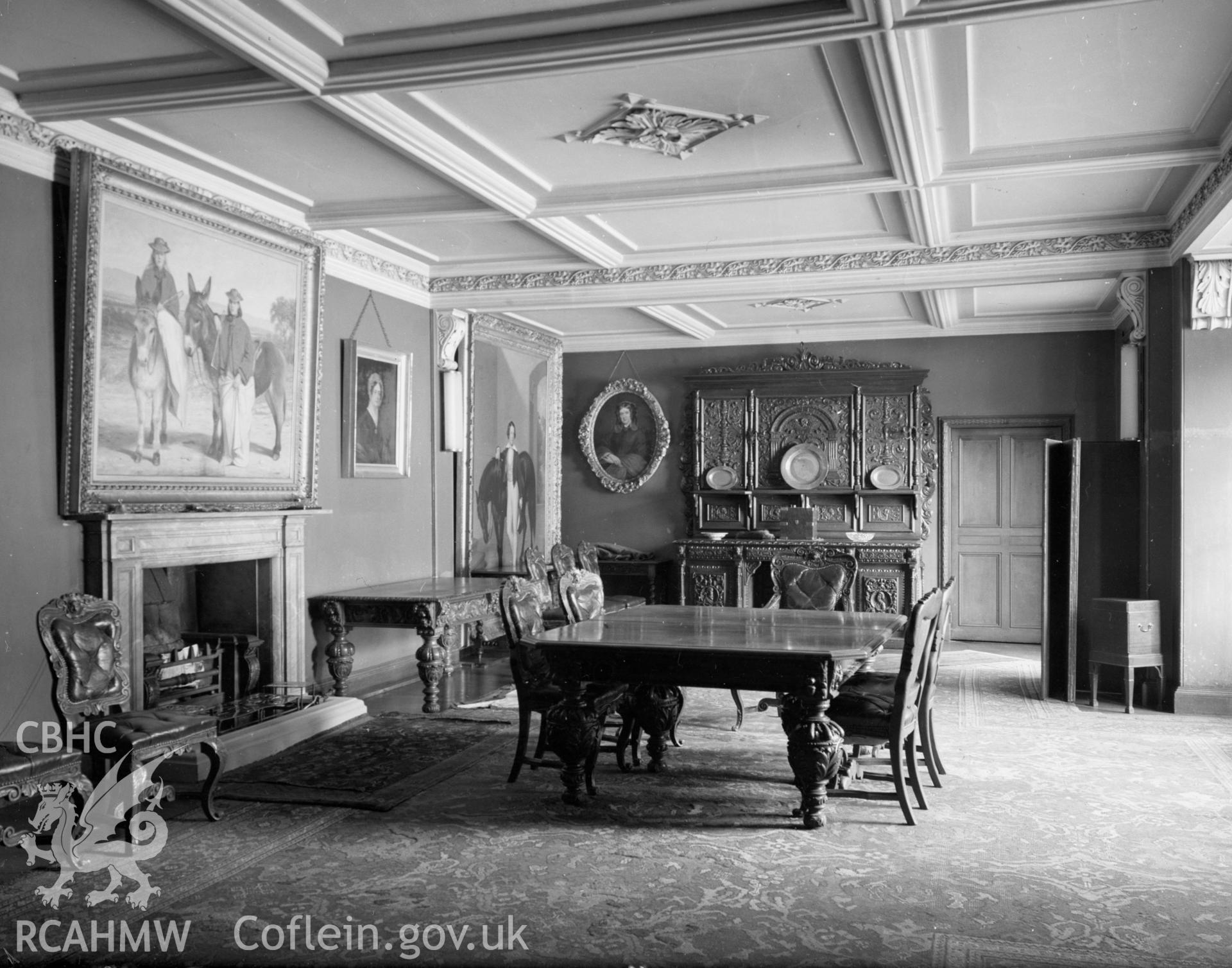 A view of the dining room showing the moulded beams on the ceiling and wooden floor.