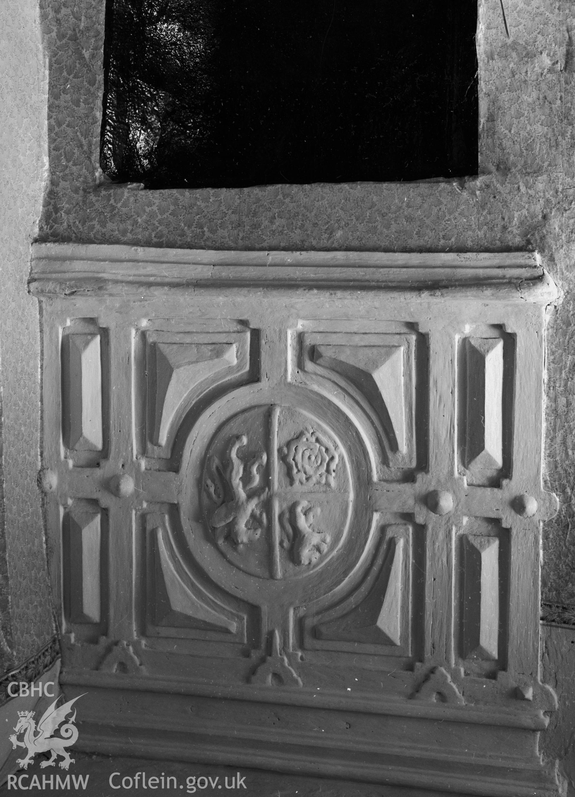 A simple fireplace with a plasterwork situated above.