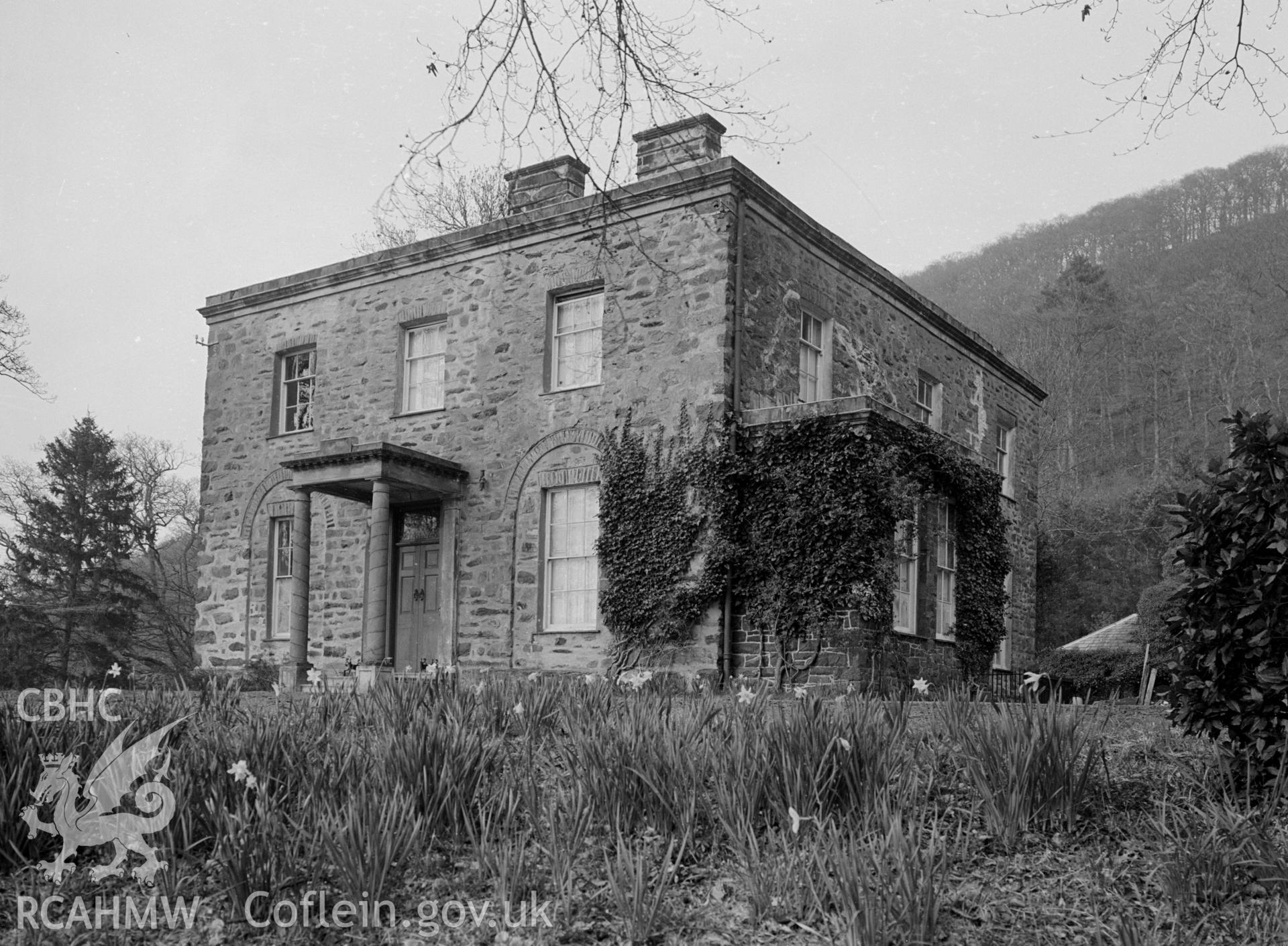 A view of a 19th century mansion of ashlar with moulded cornice. A Roman Doric porch.