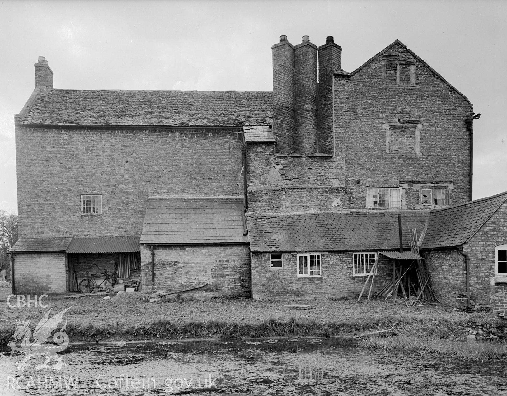 The northern side of the building showing a ground floor extension and series of stone lean-to's.