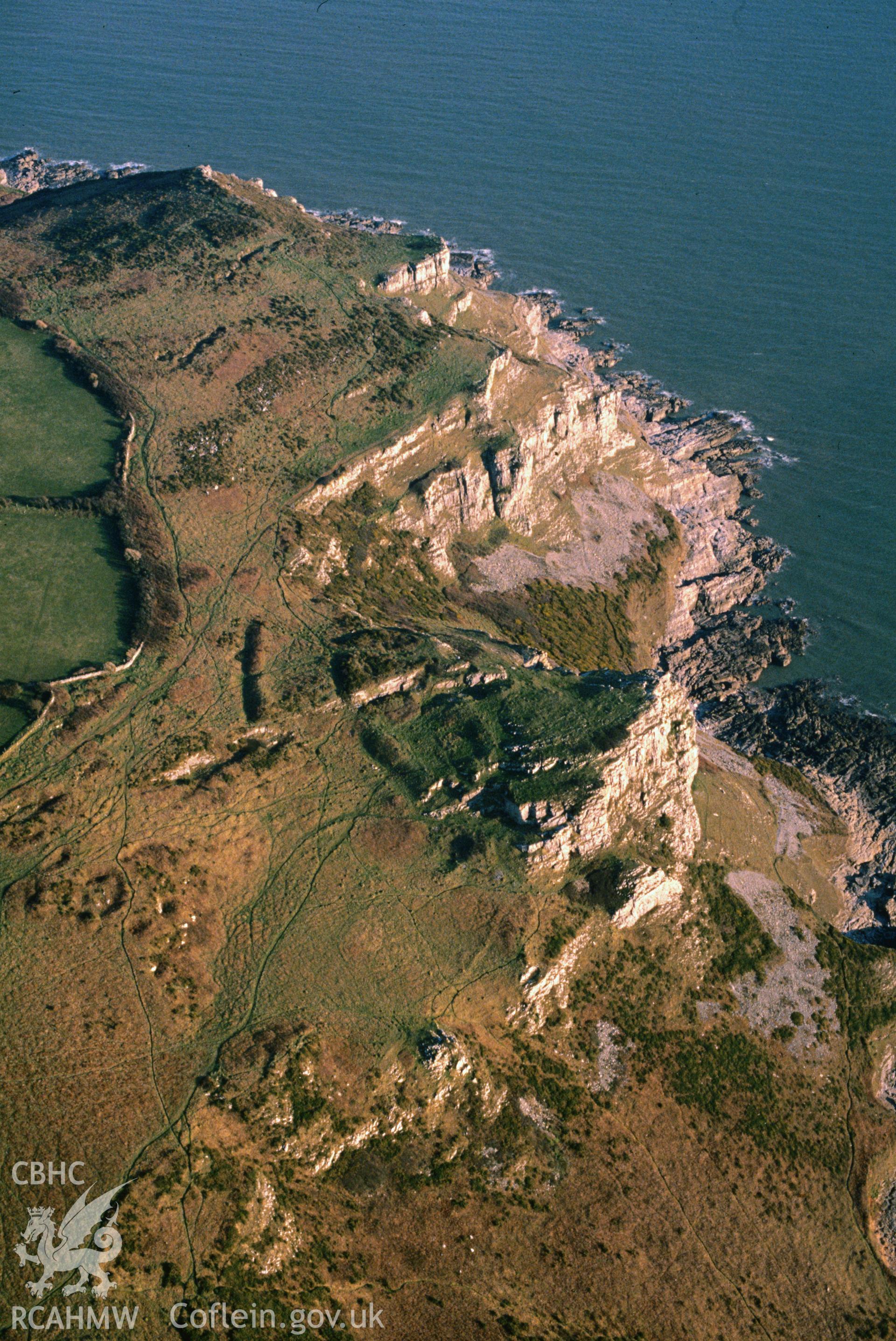 Slide of RCAHMW colour oblique aerial photograph of High Pennard Hillfort, taken by C.R. Musson, 25/3/1991.