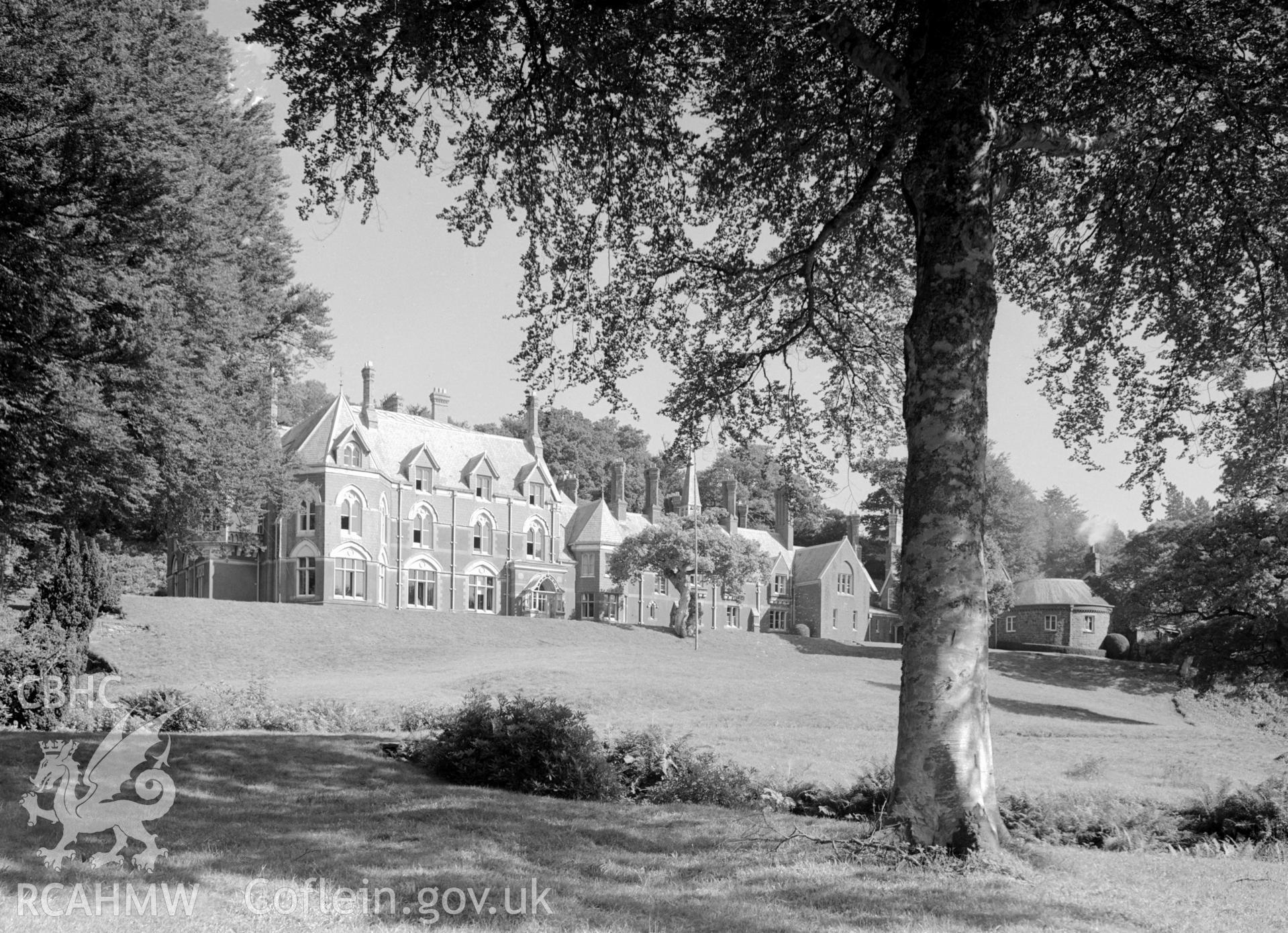 A large country mansion, two and three storeys high.