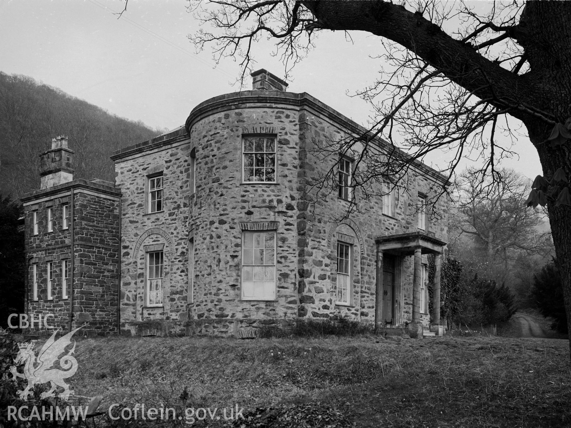 North west view of Hendre house. The house edges are rounded. Roman Doric pillars support the porch