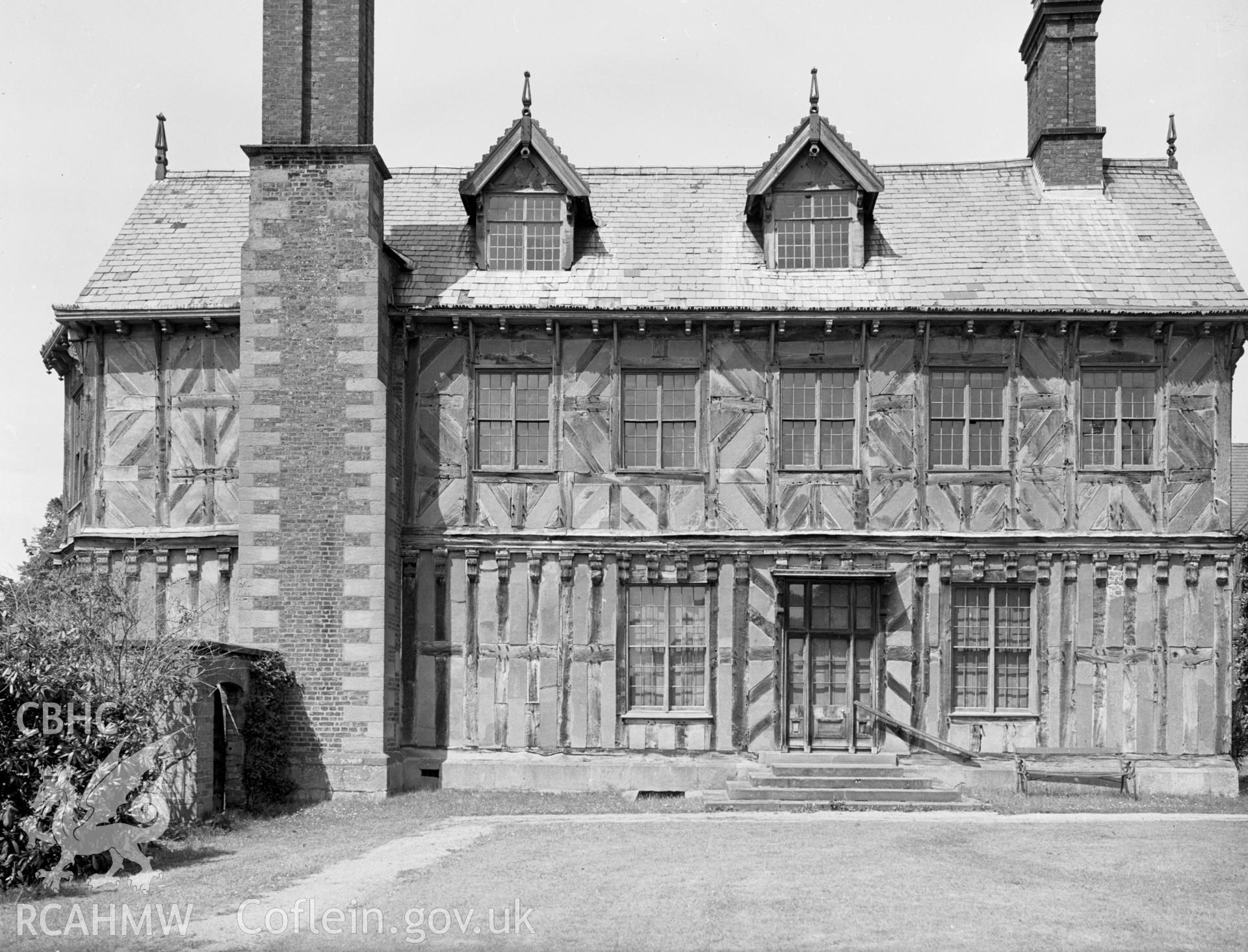 Broughton hall from the south. A tall brick chimney can be seen down the entire side of the house.