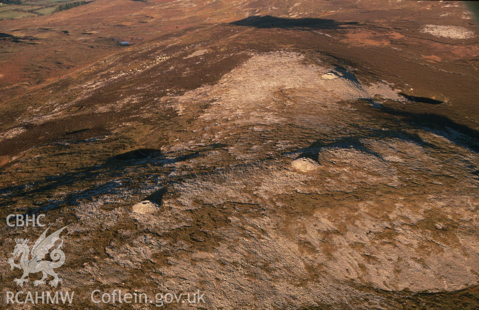 Slide of RCAHMW colour oblique aerial photograph of Tair Carn Uchaf Cairns, taken by C.R. Musson, 13/1/1991.