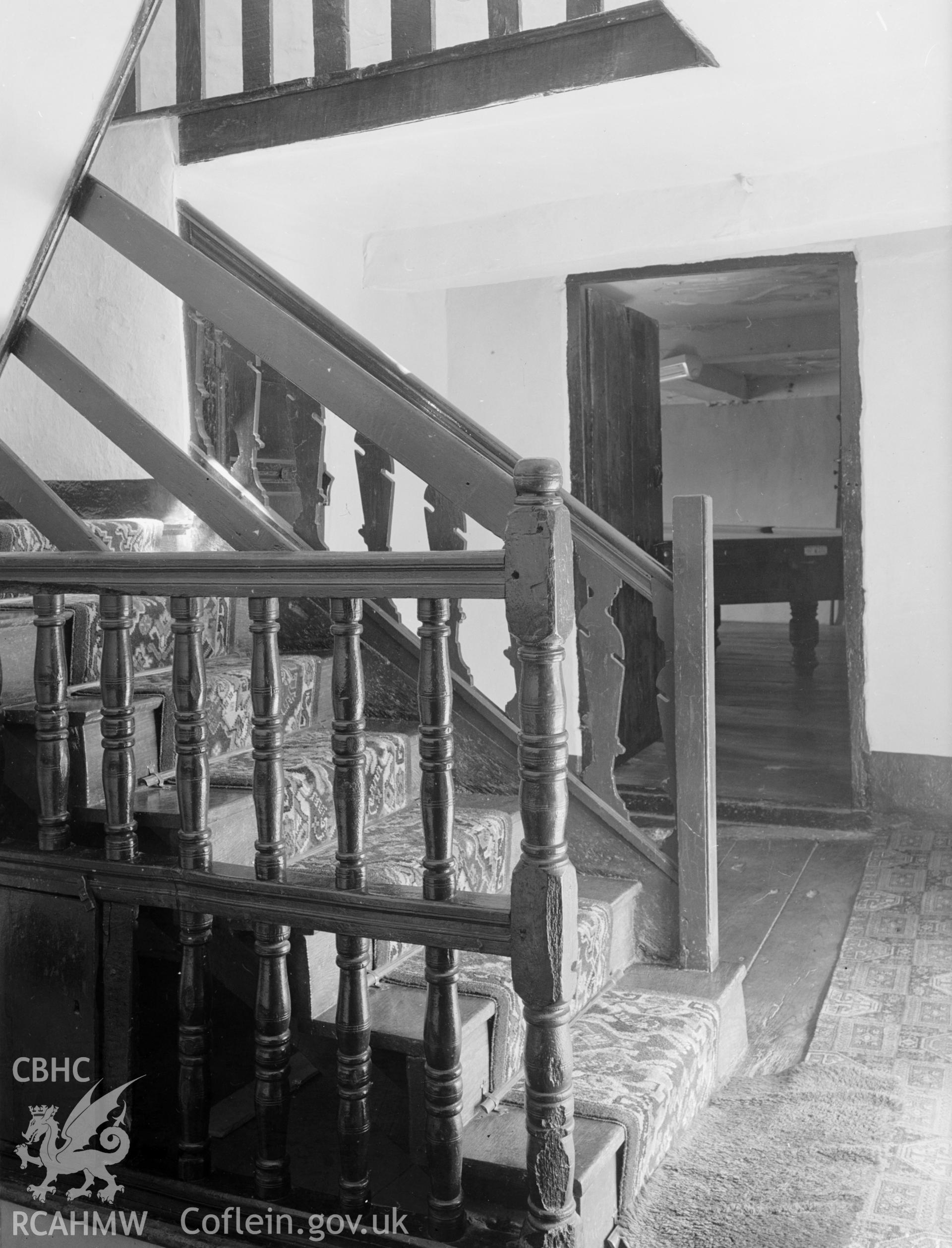 A view of the main staircase and wooden banister. Leads to a mezzanine floor.