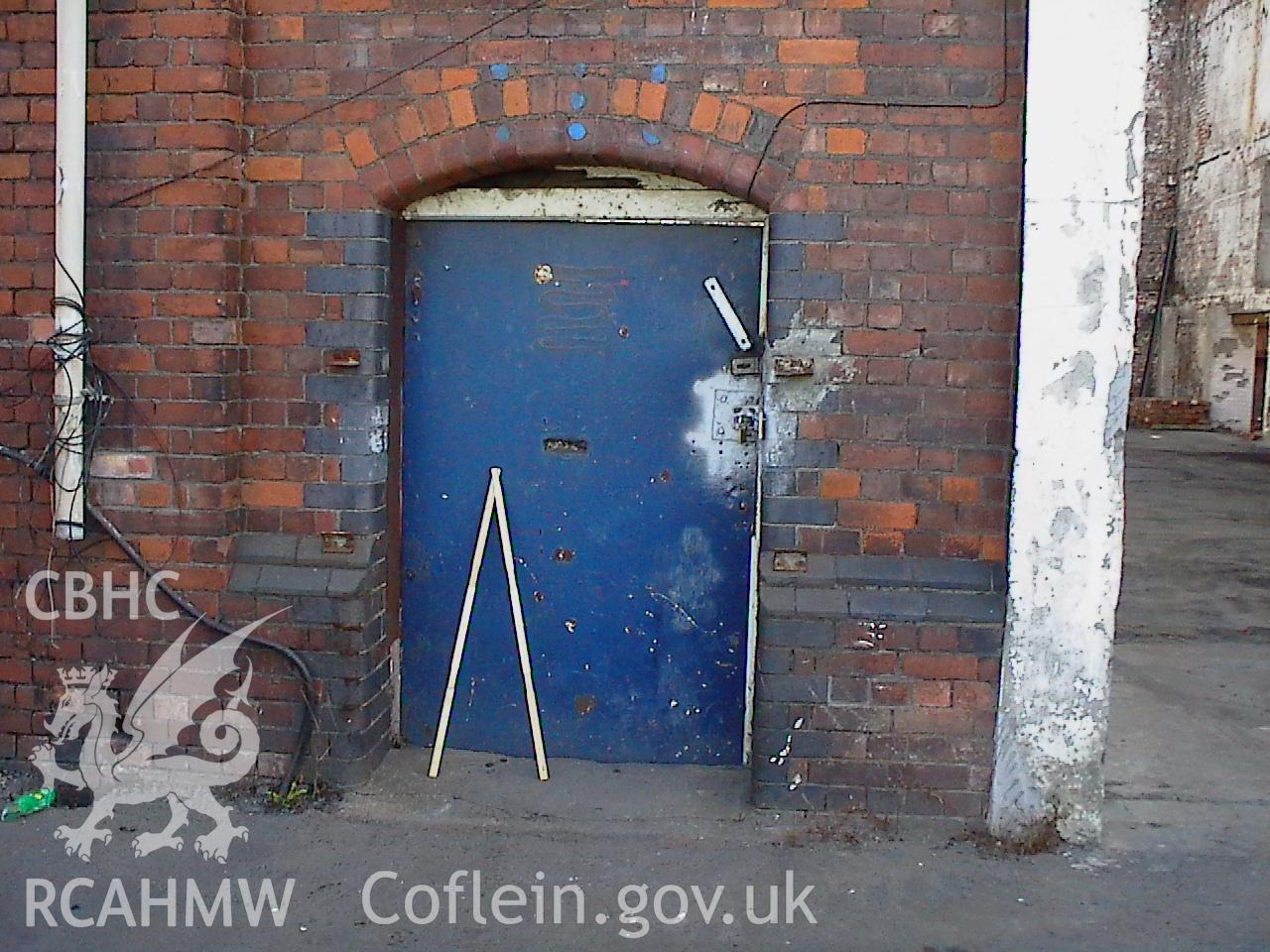 Colour digital photograph showing part of an exterior wall and a door at the Malt House, East Dock Road, Newport.  The photograph was taken after the Malt House was severely damaged by fire.