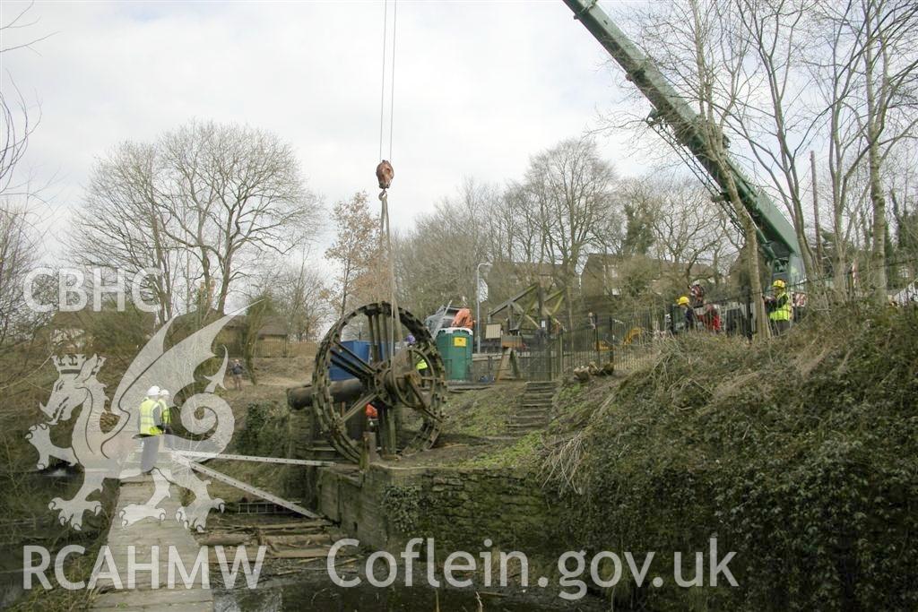 Digital image relating to Melingriffith Water Pump: Wheel rims, axle, and crank arms being lifted away in one-piece.