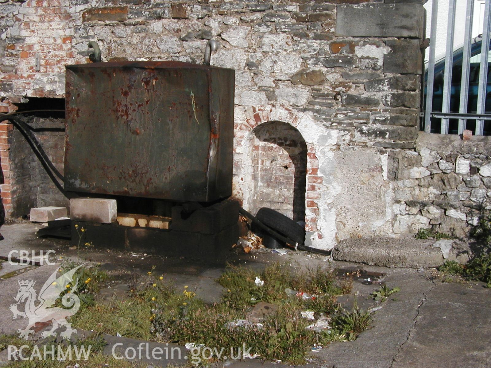 Digital colour photograph showing an arched opening and fireplace in North Wall of Newport Cattle market.