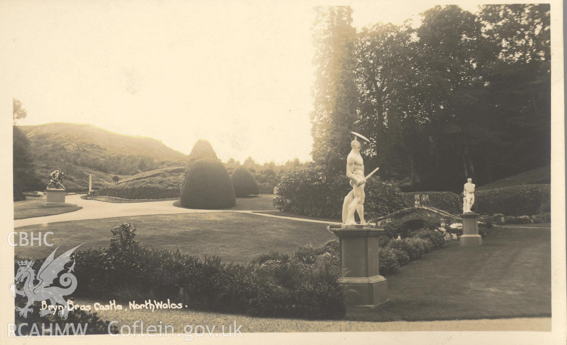 Digitised postcard image of Bryn Bras Castle garden, Llanrug, with gladiator statues. Produced by Parks and Gardens Data Services, from an original item in the Peter Davis Collection at Parks and Gardens UK. We hold only web-resolution images of this collection, suitable for viewing on screen and for research purposes only. We do not hold the original images, or publication quality scans.