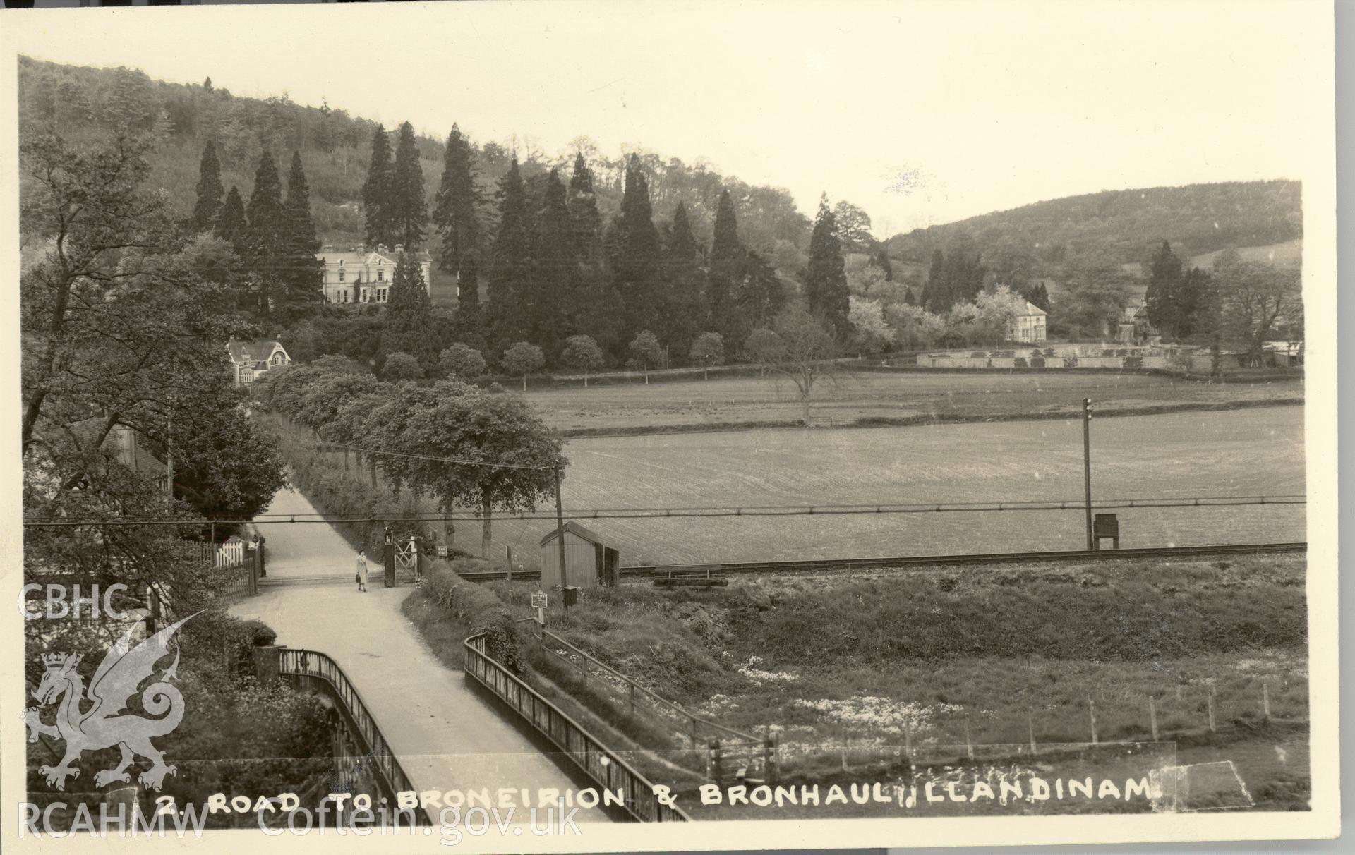 Digitised postcard image of Broneirion, Llandinam, showing bridge, railway and figure, Pickfords, Photographers, Aberystwyth. Produced by Parks and Gardens Data Services, from an original item in the Peter Davis Collection at Parks and Gardens UK. We hold only web-resolution images of this collection, suitable for viewing on screen and for research purposes only. We do not hold the original images, or publication quality scans.