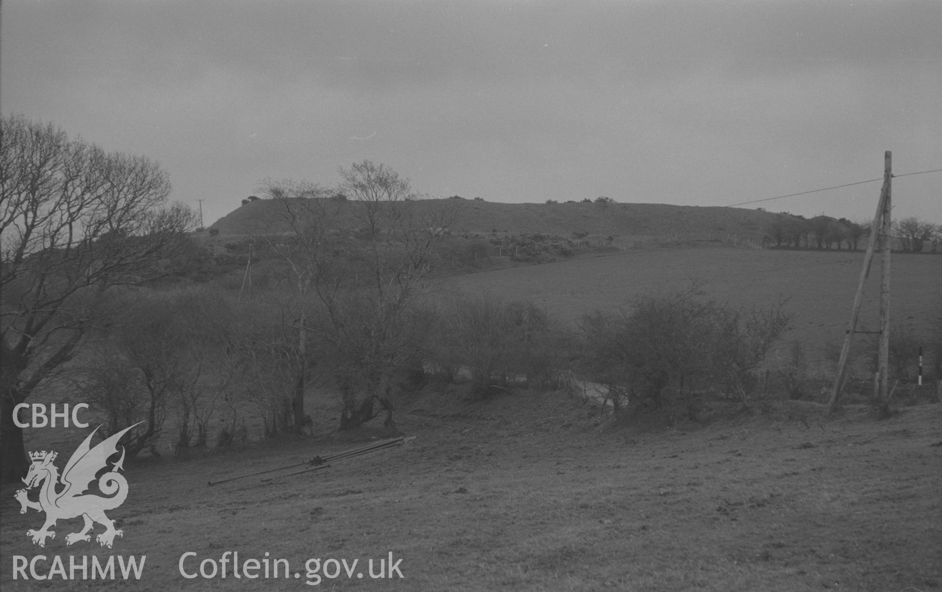 Black and White photograph showing Castell Fflemish iron-age camp from across the main road, Tregaron. Photographed by Arthur Chater in December 1961 from Grid Reference SN 653 634, looking south east.