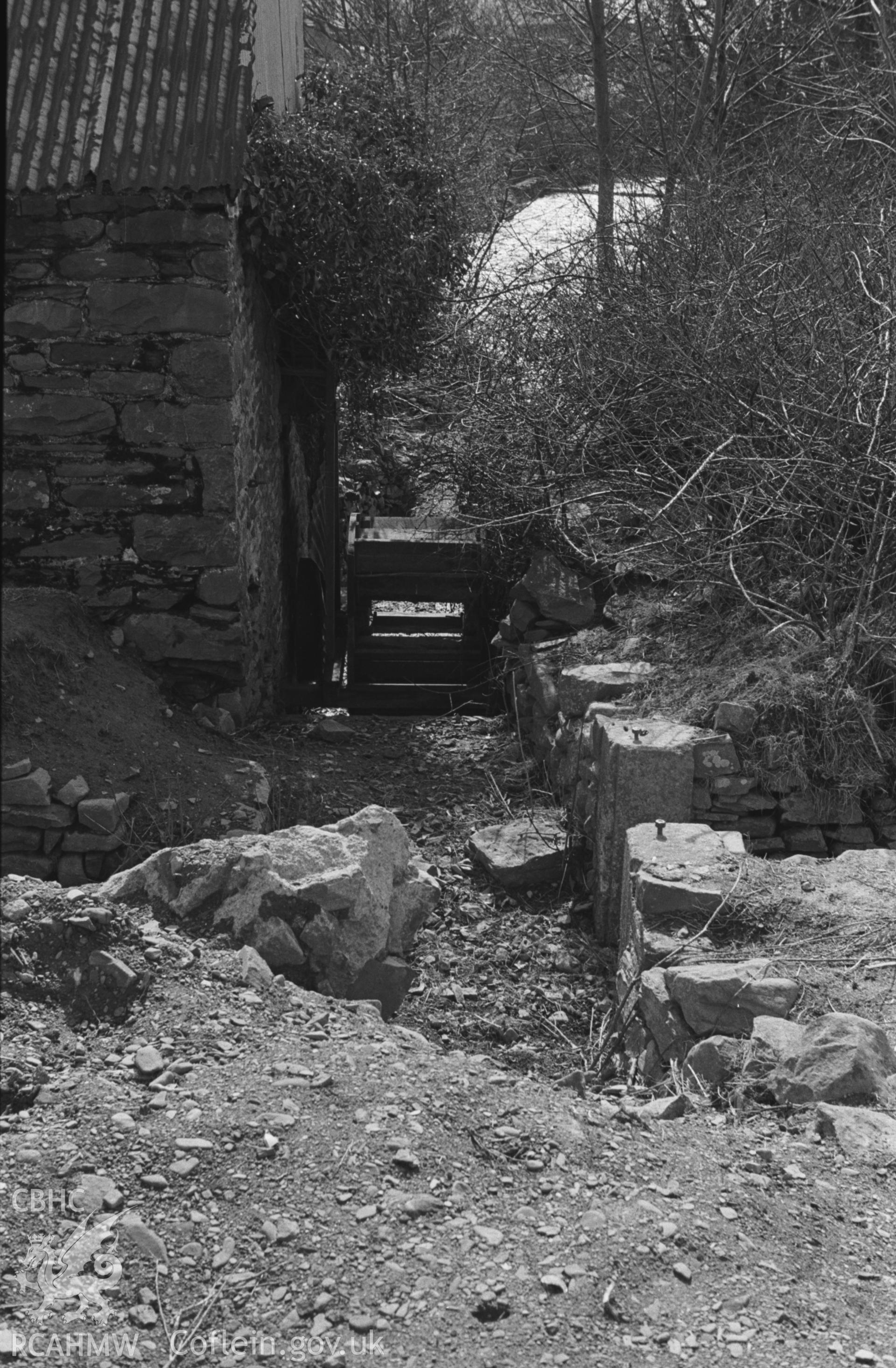 Black and White photograph showing waterwheel of the Yarn Factory at the side of the Wyre below the road bridge, Llanrhystyd. (The original wheel was much larger). Photographed by Arthur Chater in April 1963 from Grid Reference SN 539 696, looking south-west.