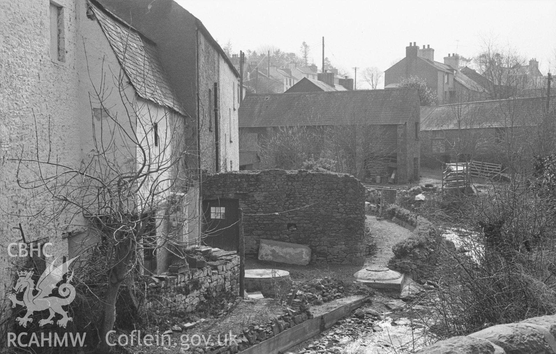 Black and White photograph showing view up the afon Llethi in Llanarth village from the bridge leading to the church. Photographed by Arthur Chater in April 1963 from Grid Reference SN 424 576, looking south west.