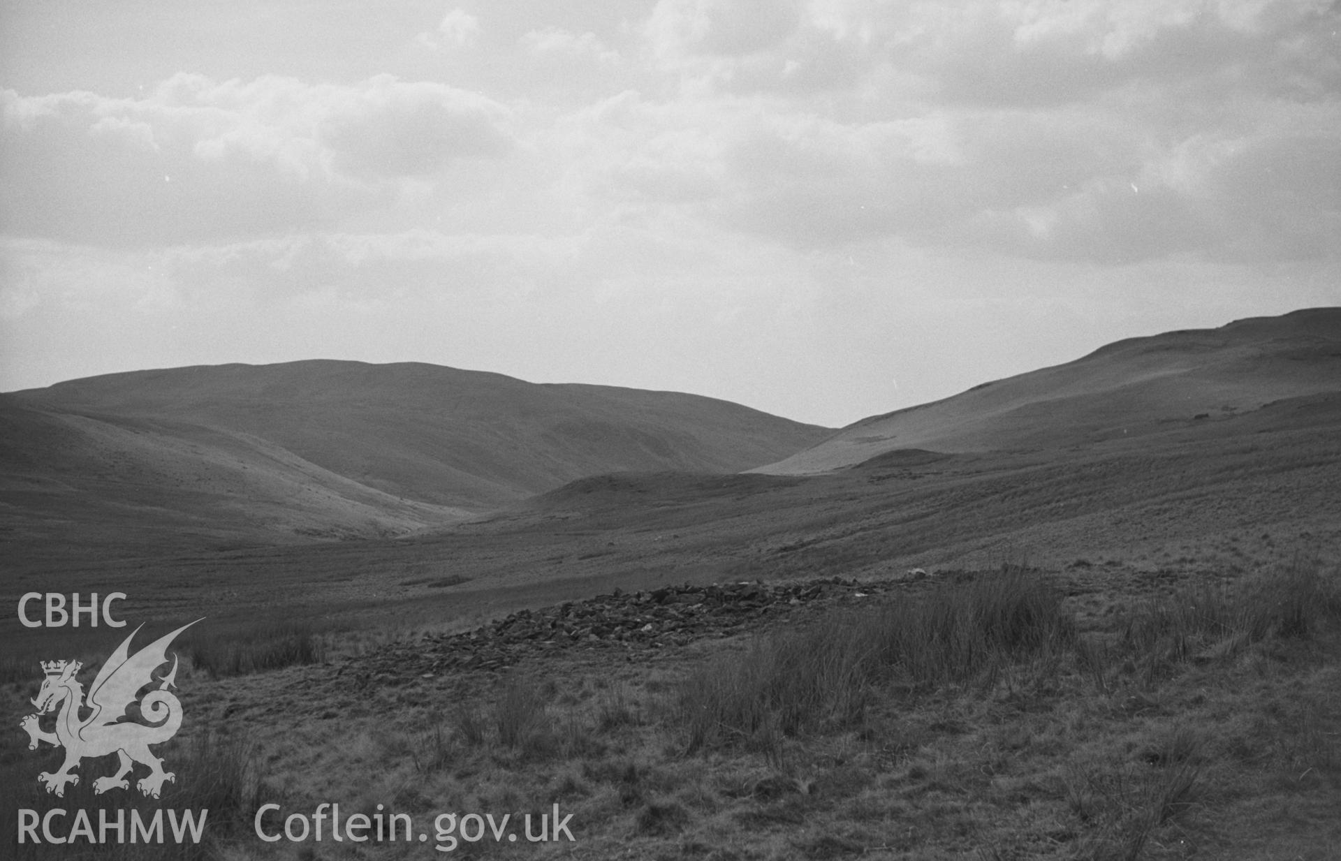 Black and White photograph showing view looking over the cairn at 1420ft. and down the afon Groes Fawr; track almost hidden in the bog. Photographed by Arthur Chater in April 1962 from Grid Reference SN 745 595, looking west south west.