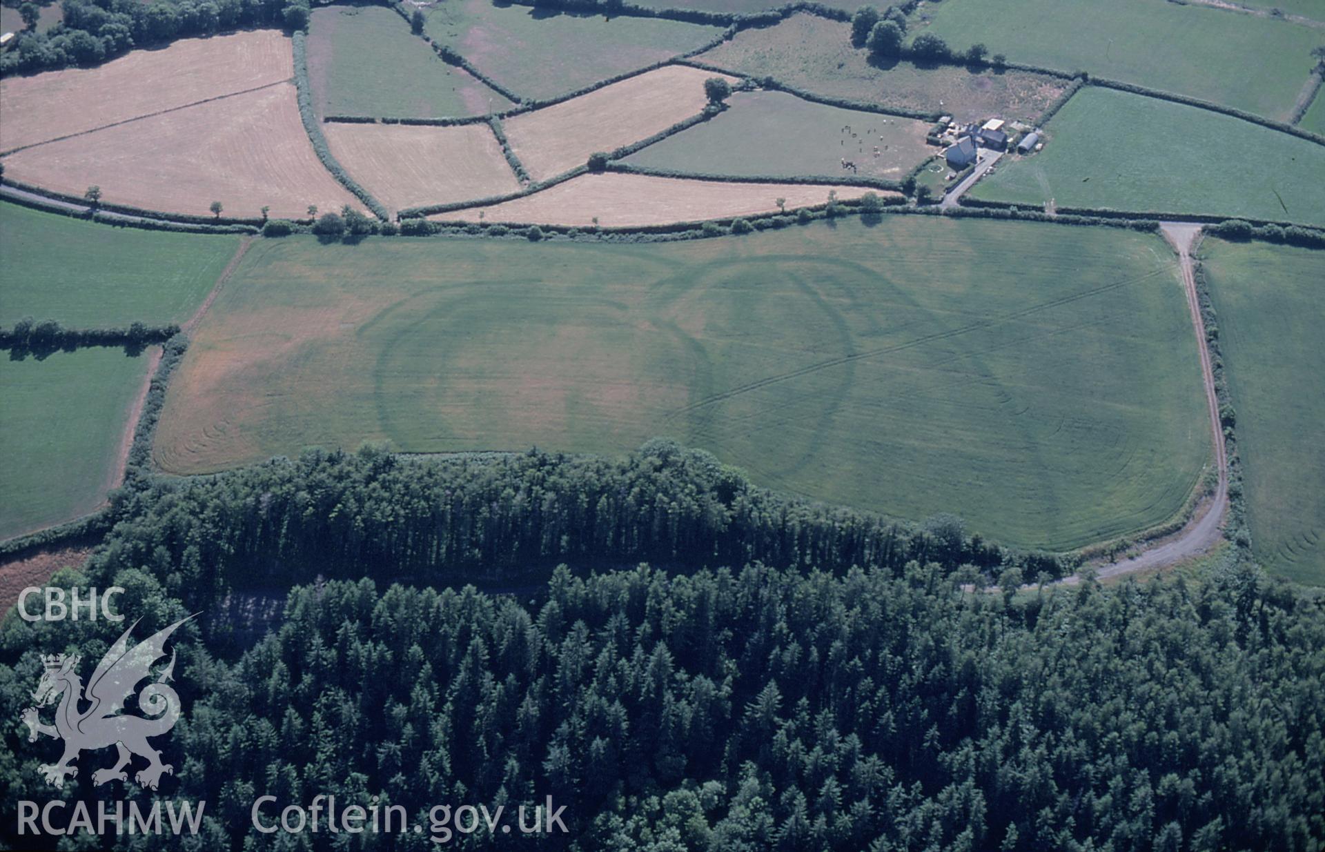 RCAHMW colour slide oblique aerial photograph of enclosure complex at Gelli Diogyn, Llanboidy, taken by C.R.Musson on the 25/07/1996