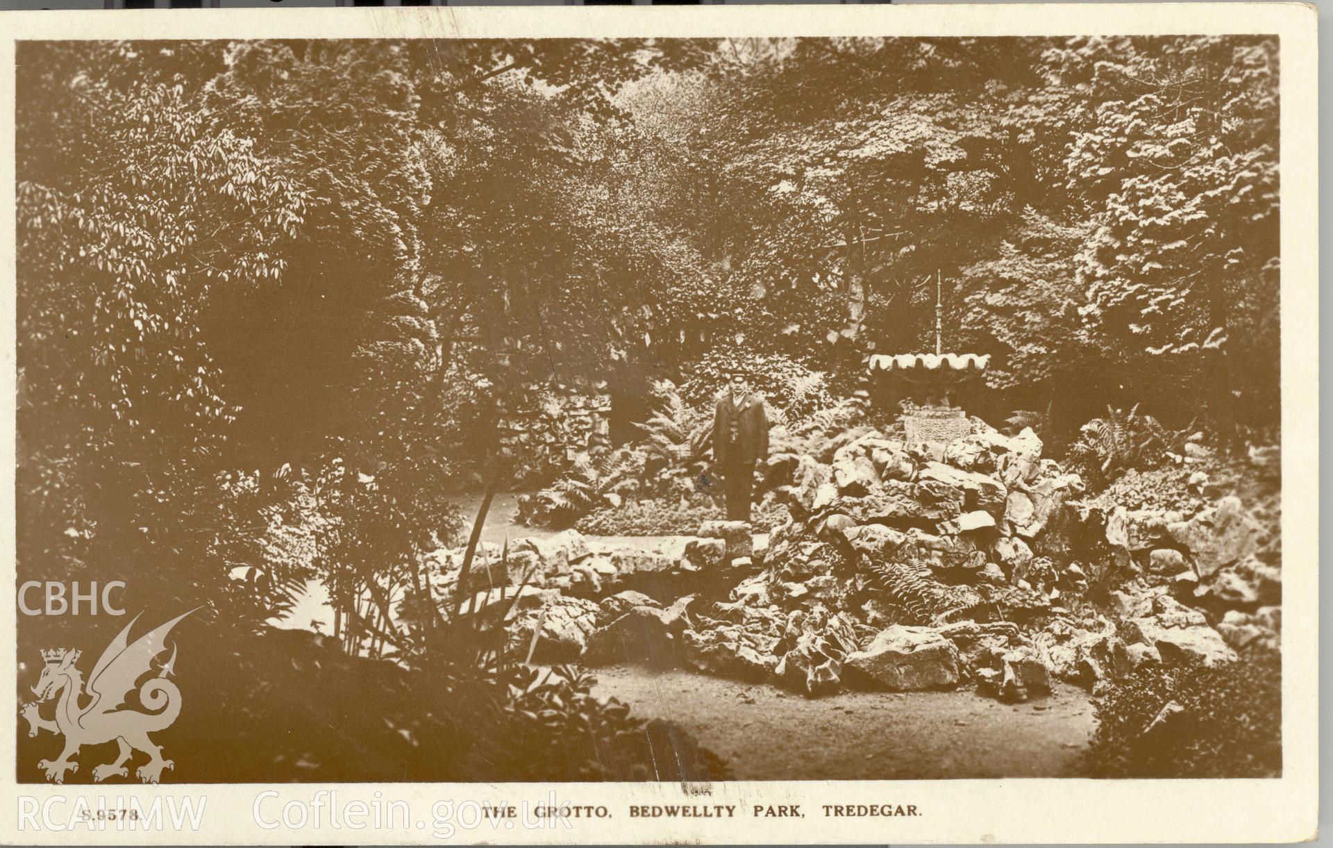 Digitised postcard image of the Grotto, Bedwellty Park, Tredegar, Kingsway real Photo series. Produced by Parks and Gardens Data Services, from an original item in the Peter Davis Collection at Parks and Gardens UK. We hold only web-resolution images of this collection, suitable for viewing on screen and for research purposes only. We do not hold the original images, or publication quality scans.