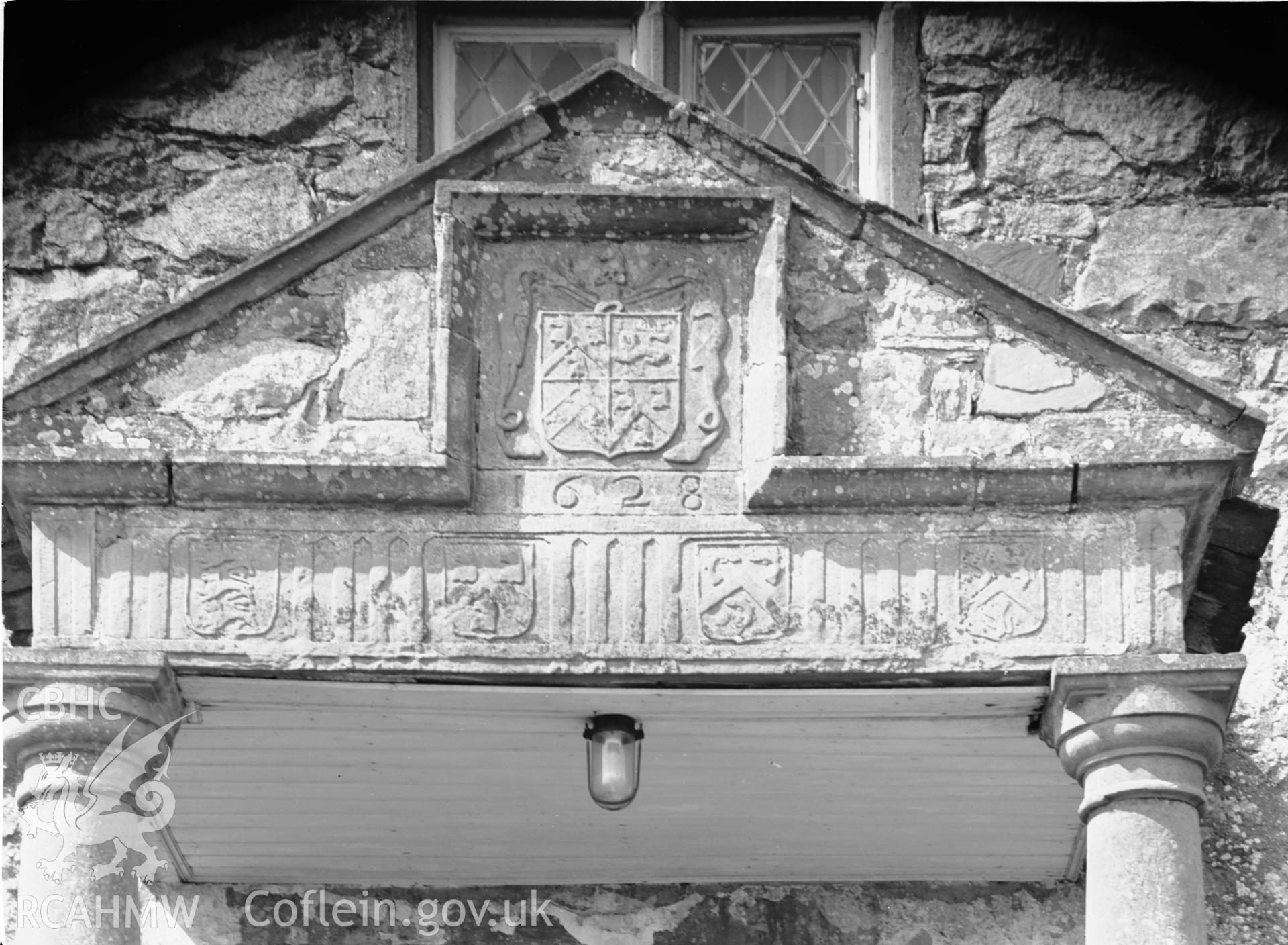 Exterior view of the house showing detail of arms panel above doorway