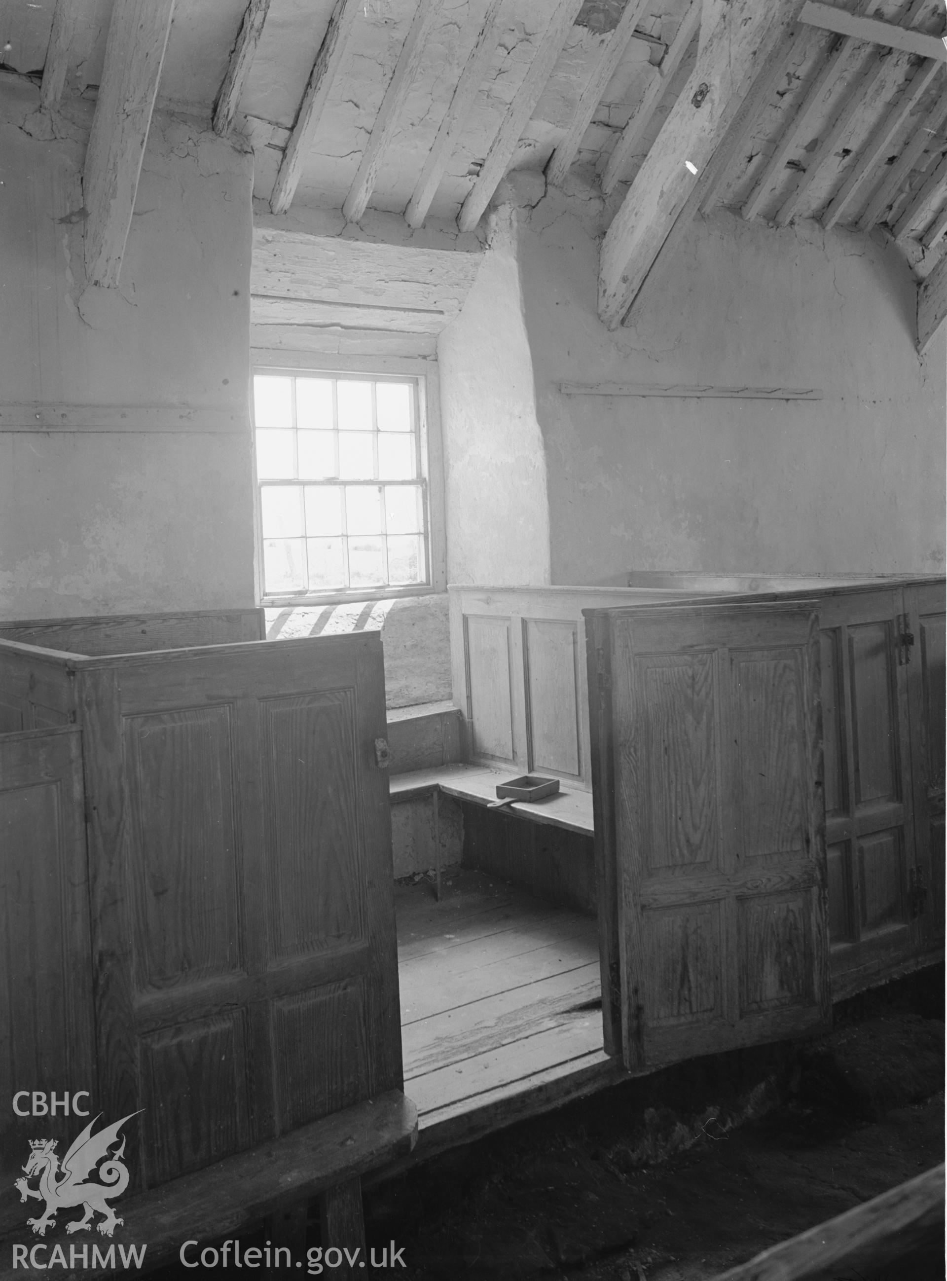 Interior view showing pews and south window.