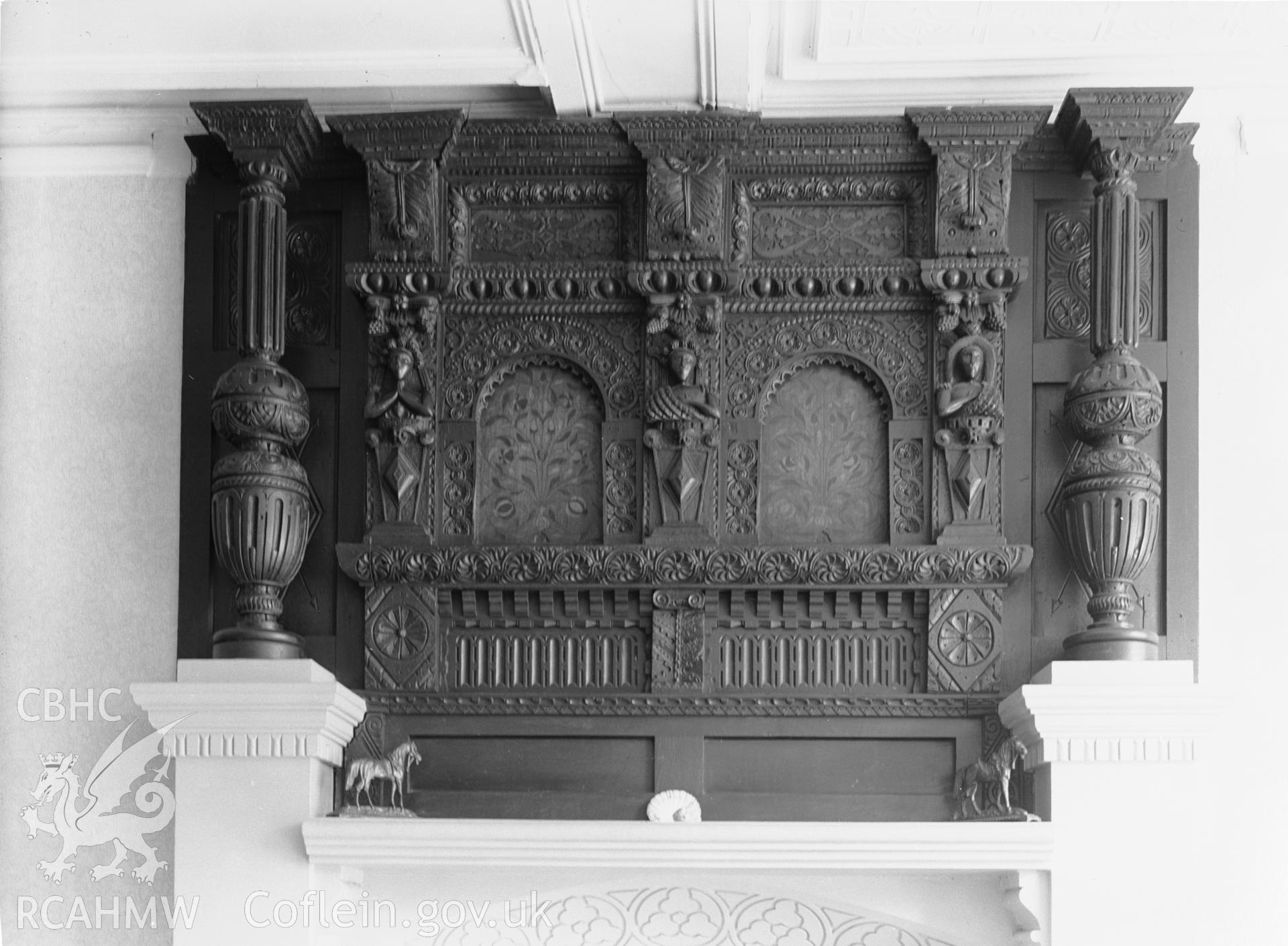 Interior: carved bed-head over fireplace