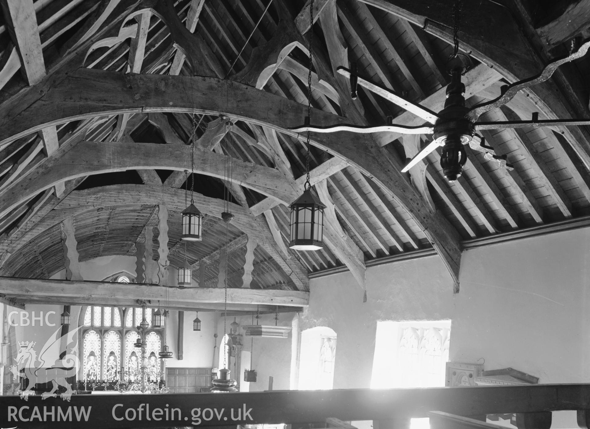 Interior: roof timbers from west gallery and wooden candelabra