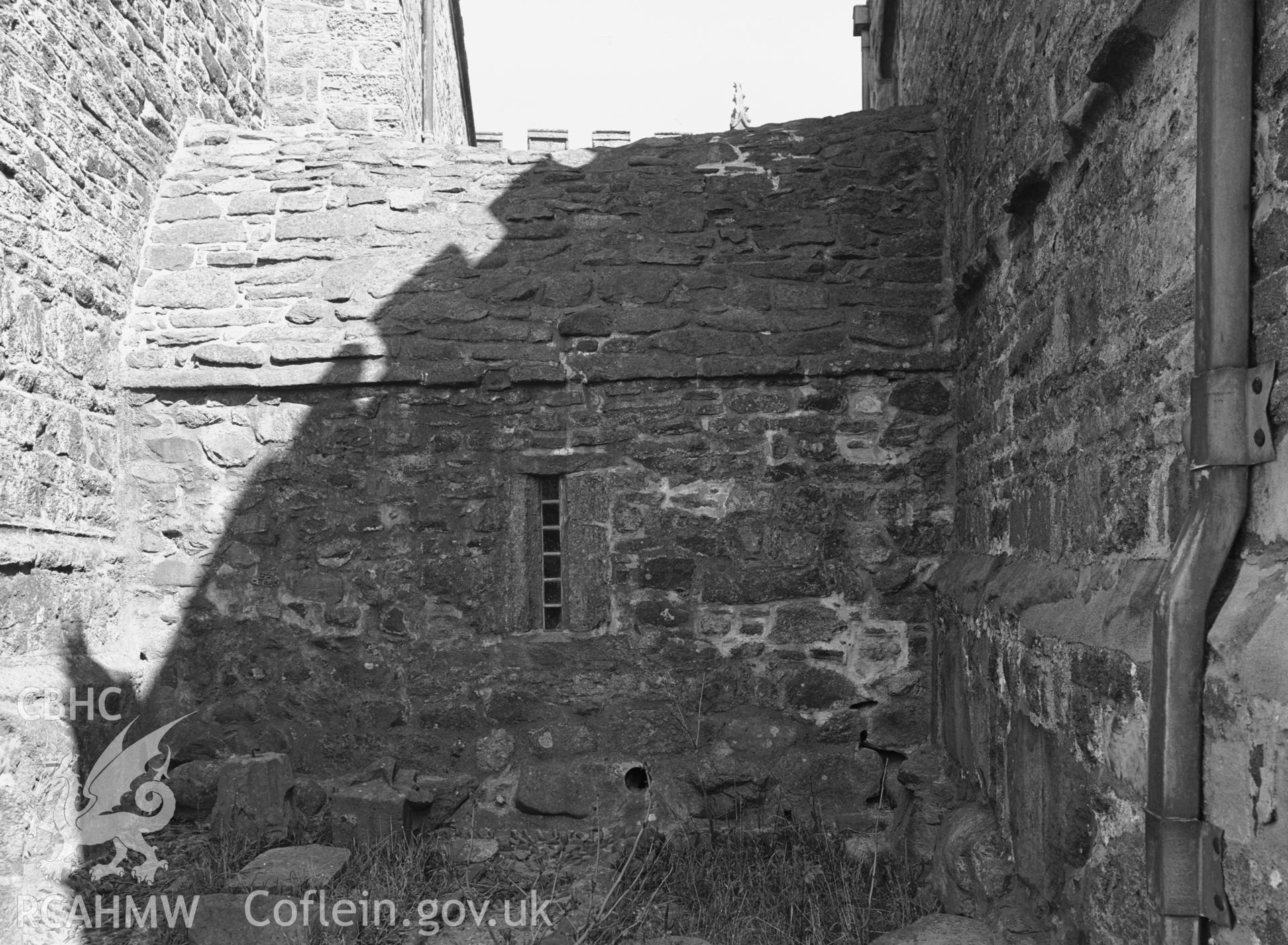 Exterior view showing the west elevation of the slype (covered passage) between the tower and the chapel.