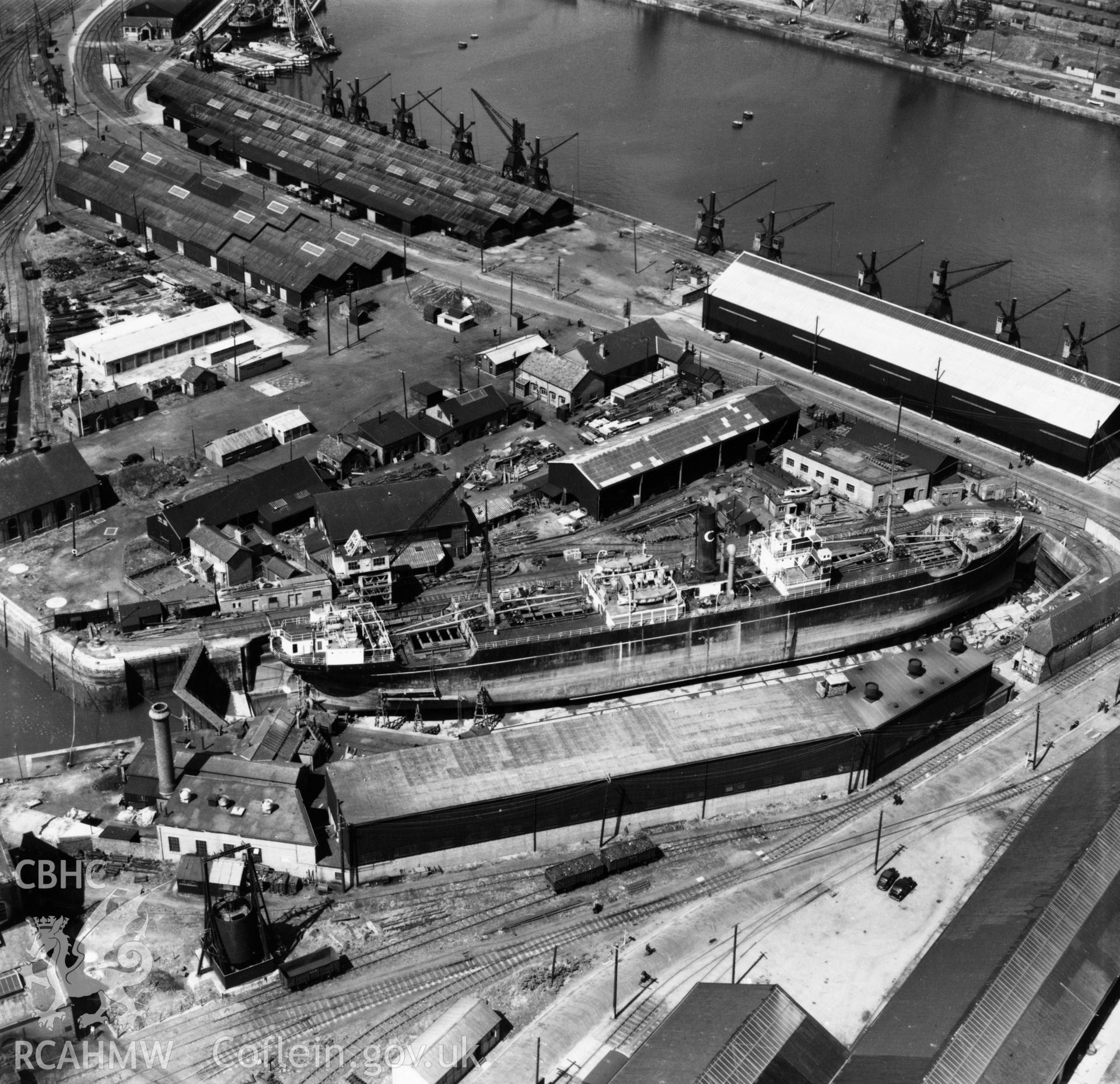 View of Prince of Wales dry dock, Swansea, showing the ship 'Pendeen' in dry dock. Oblique aerial photograph, 5?" cut roll film.