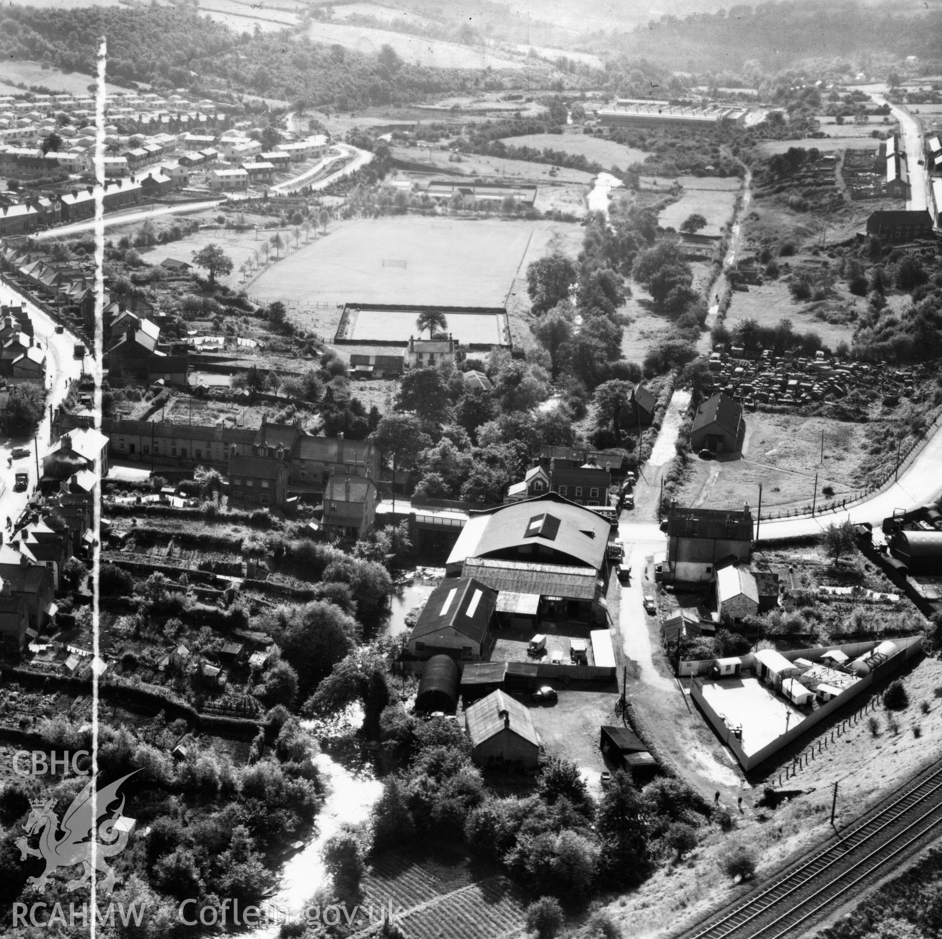 View of Gibbs Brothers garage at Pontllanfraith, also showing Welfare Ground and swimming pool. Oblique aerial photograph, 5?" cut roll film.