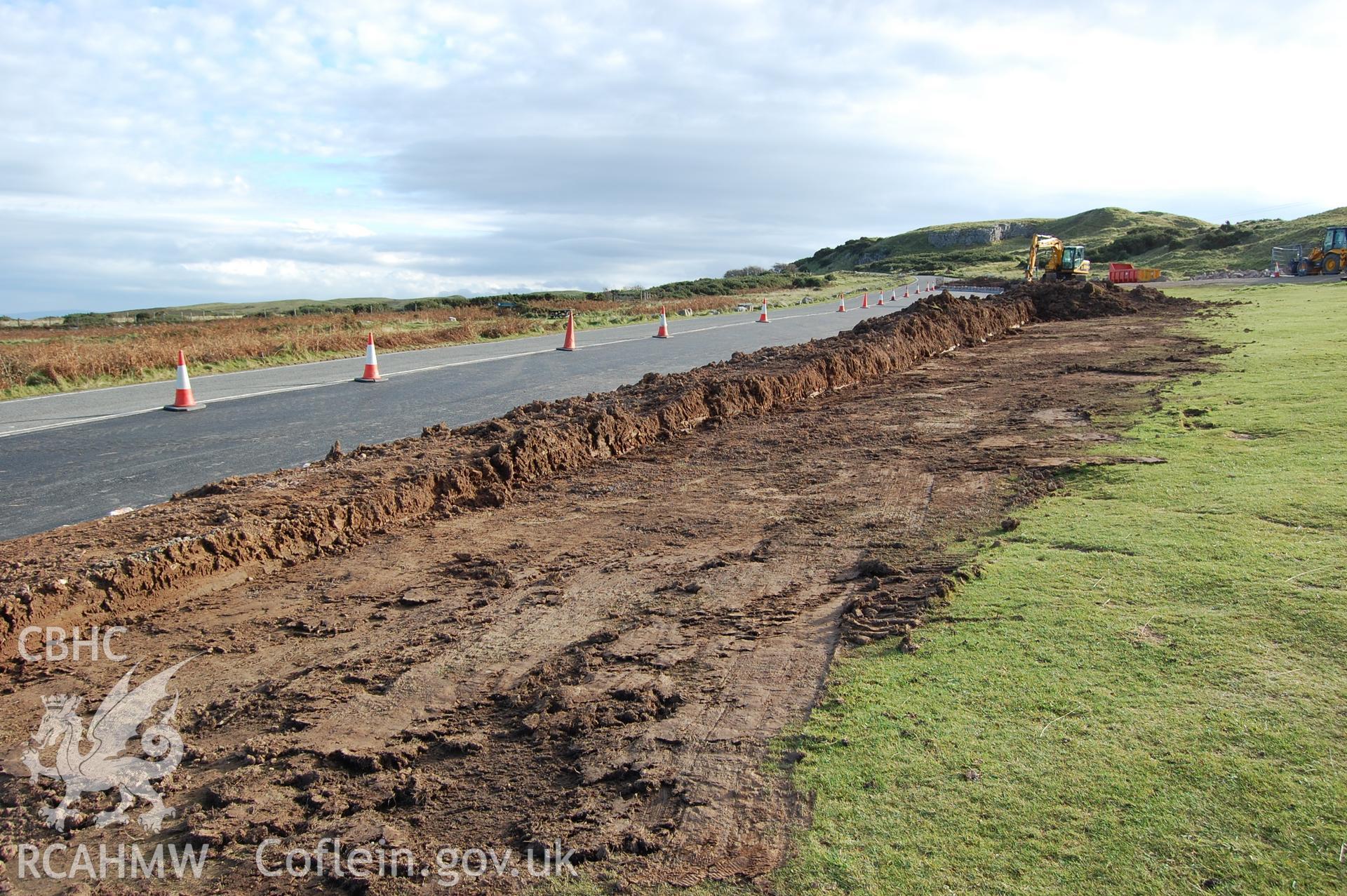 Digital photograph showing the spread of bund material removed along part of area.