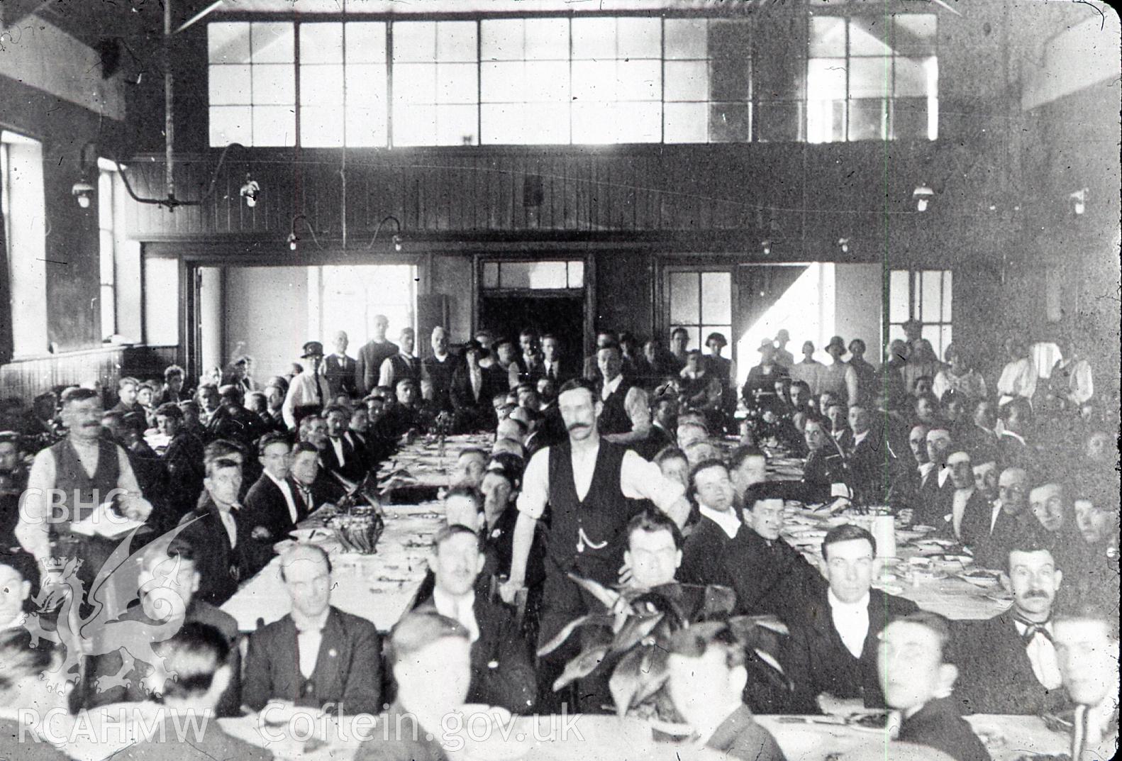 Digital copy of photograph entitled: 'St Mary's, Risca', showing men eating at tables in a hall, dated 1926.