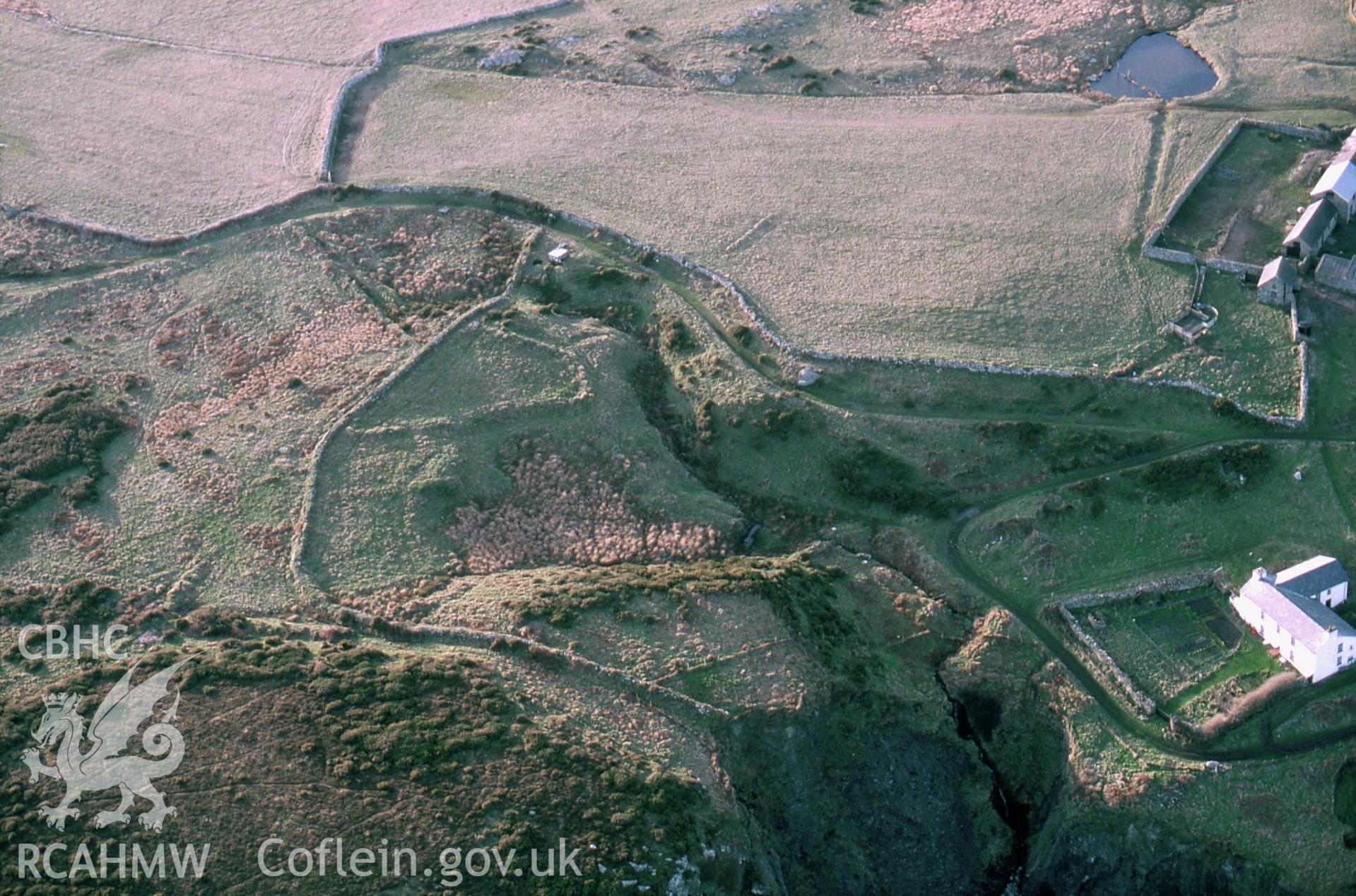 RCAHMW colour slide oblique aerial photograph of settlement & enclosure features S of Ramsey Island Farm, St Davids and the Cathedral Close, taken by C.R. Musson, 15/03/94